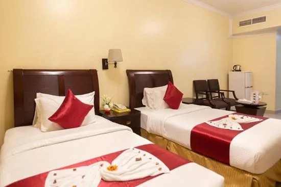 Bed in Crown Palace Hotel