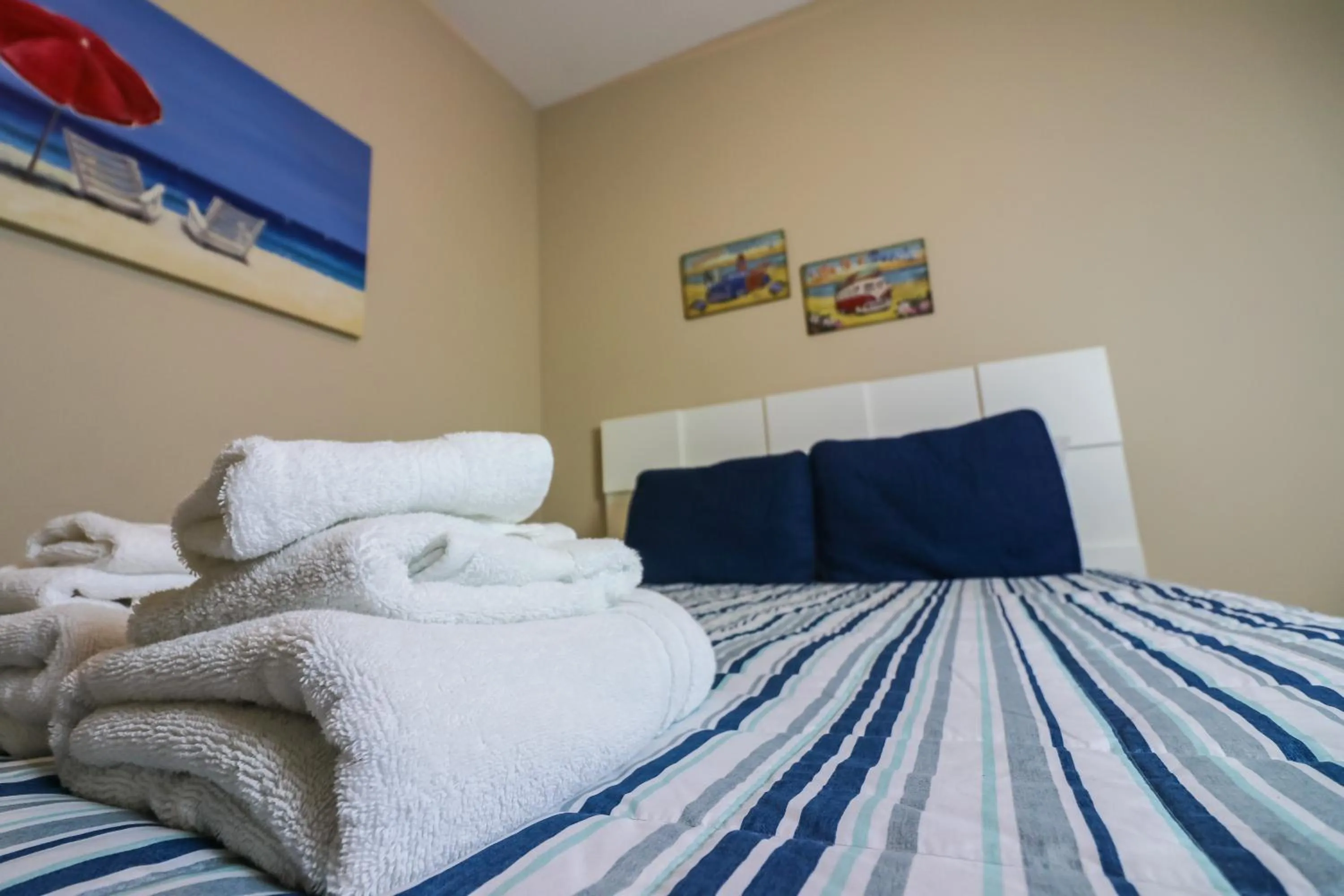 Bed in Beachfront Laid Back and Luxurious Diamond Beach Condo - Amazing Pools Amenities