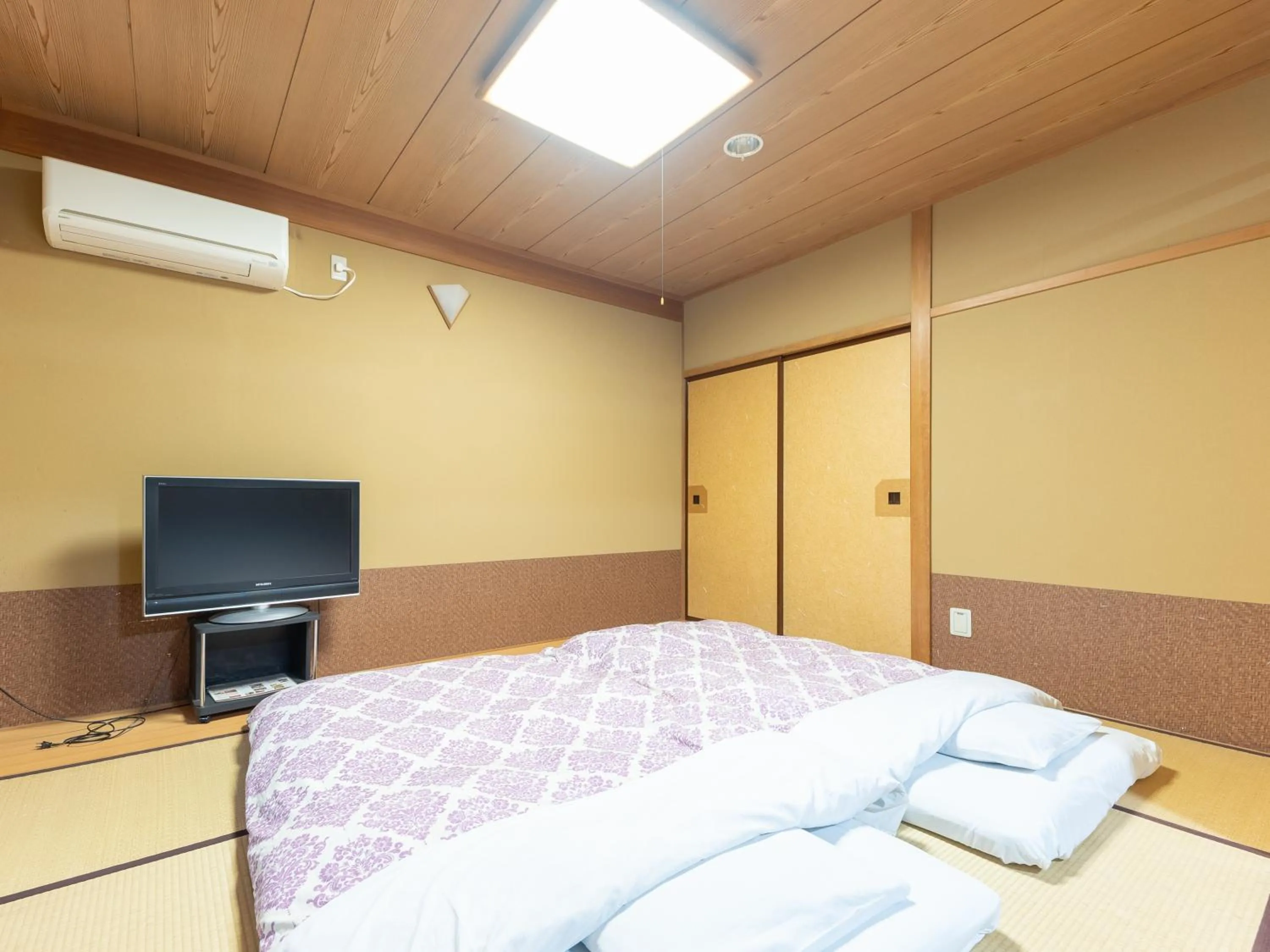 Bed in Tabist Hotel Iyashi no Sato