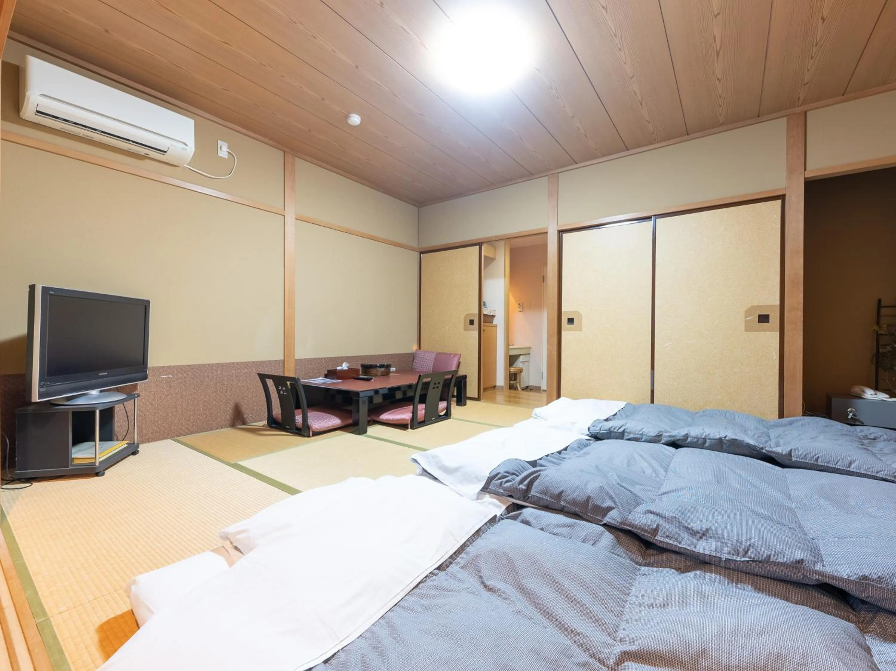Bed in Tabist Hotel Iyashi no Sato