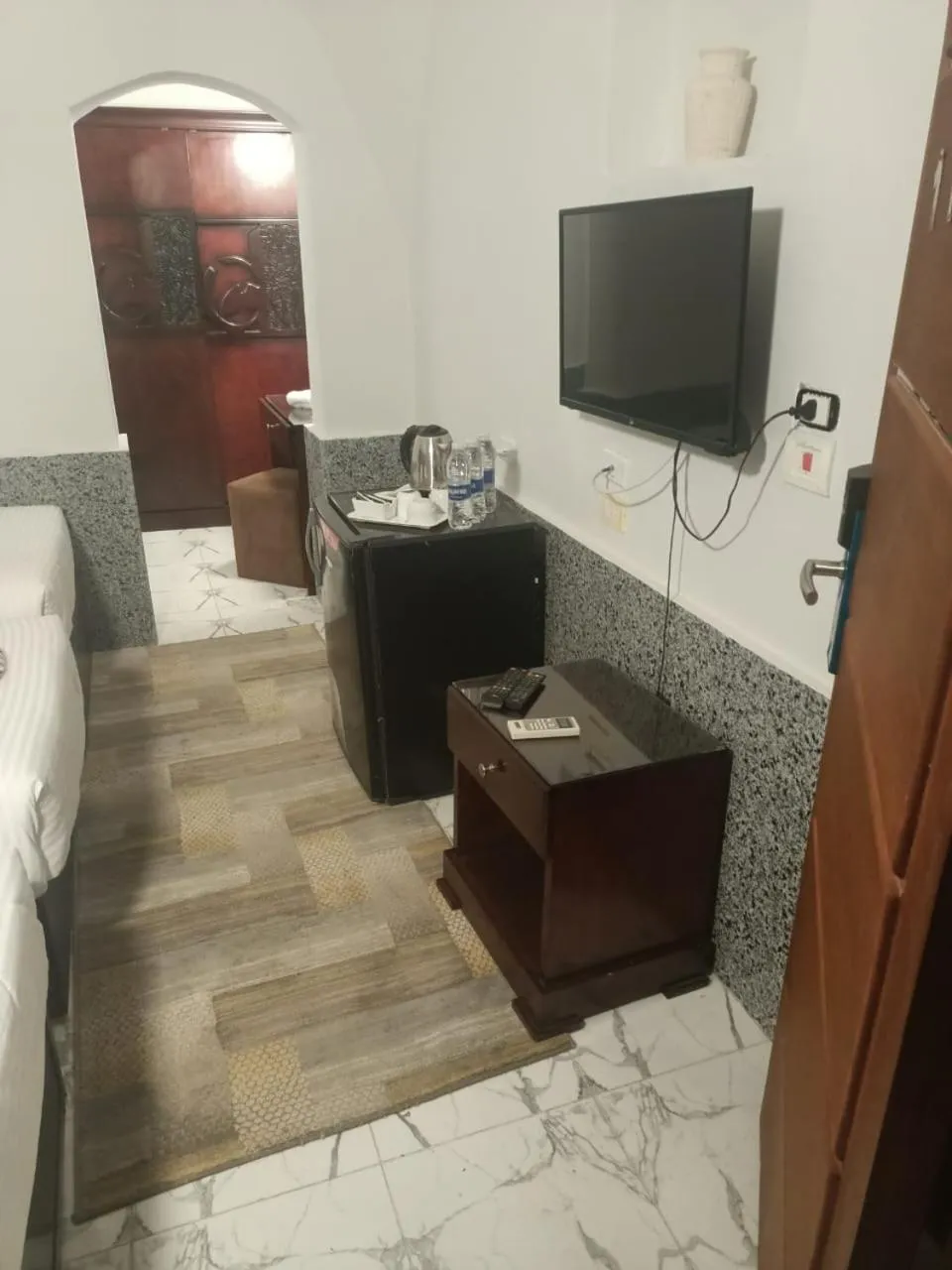 Communal lounge/ TV room, Bed in Dolphin Continental Hotel