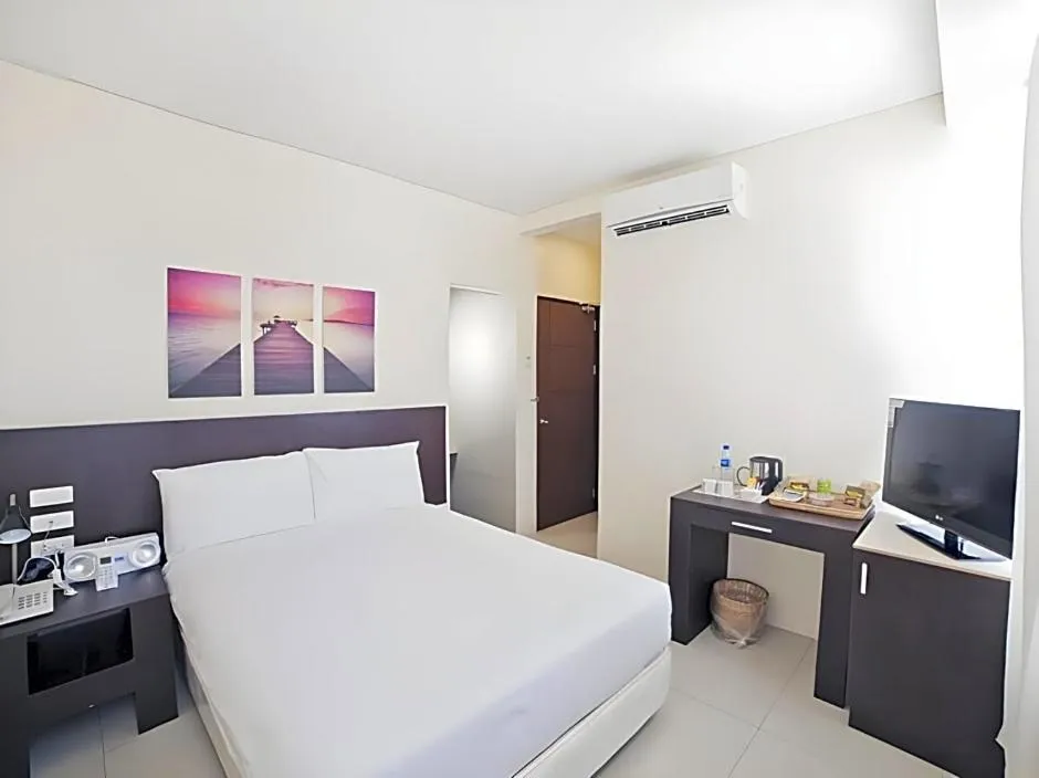 Bed in Ocean Suites Bohol Boutique Hotel