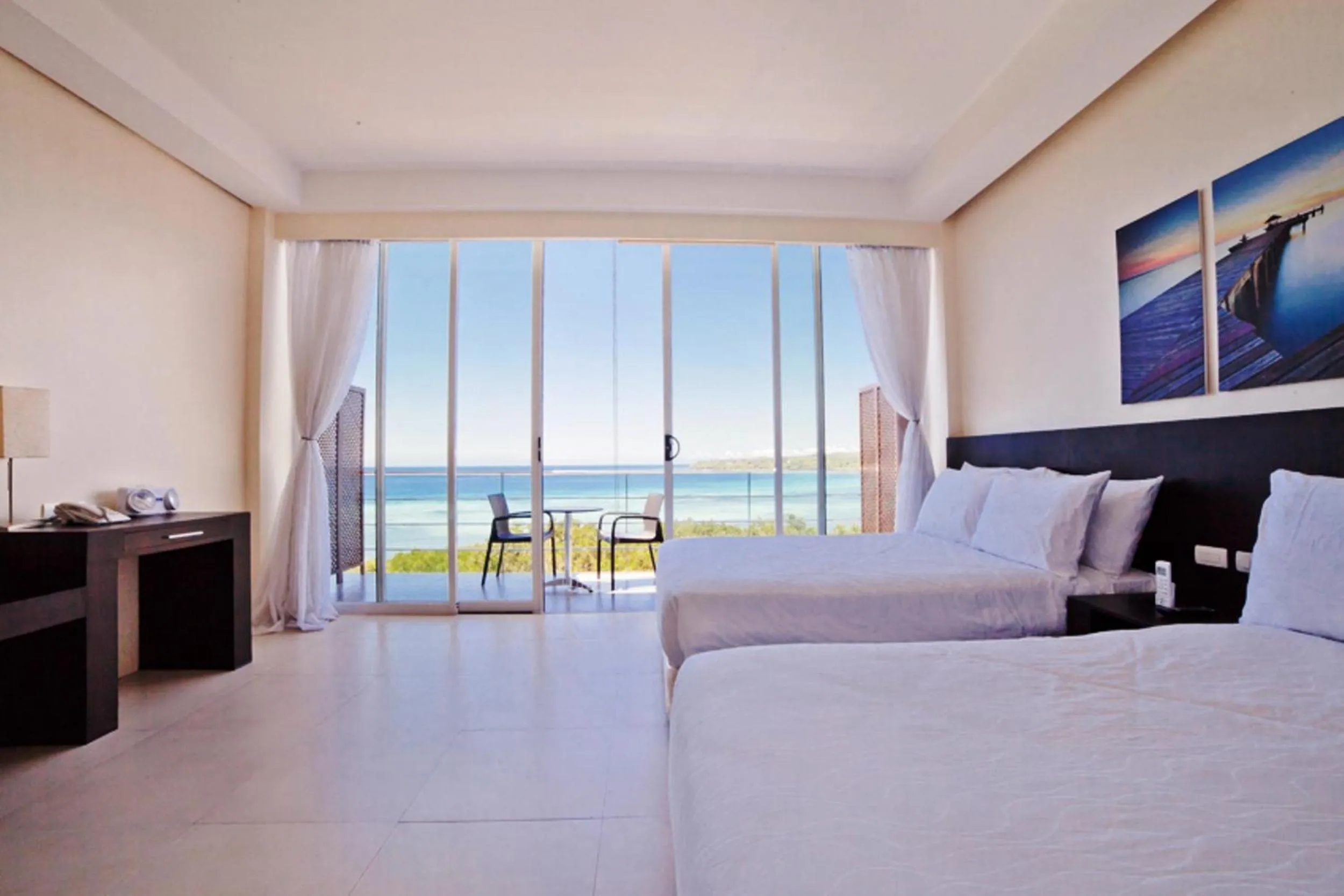 Photo of the whole room, Bed in Ocean Suites Bohol Boutique Hotel