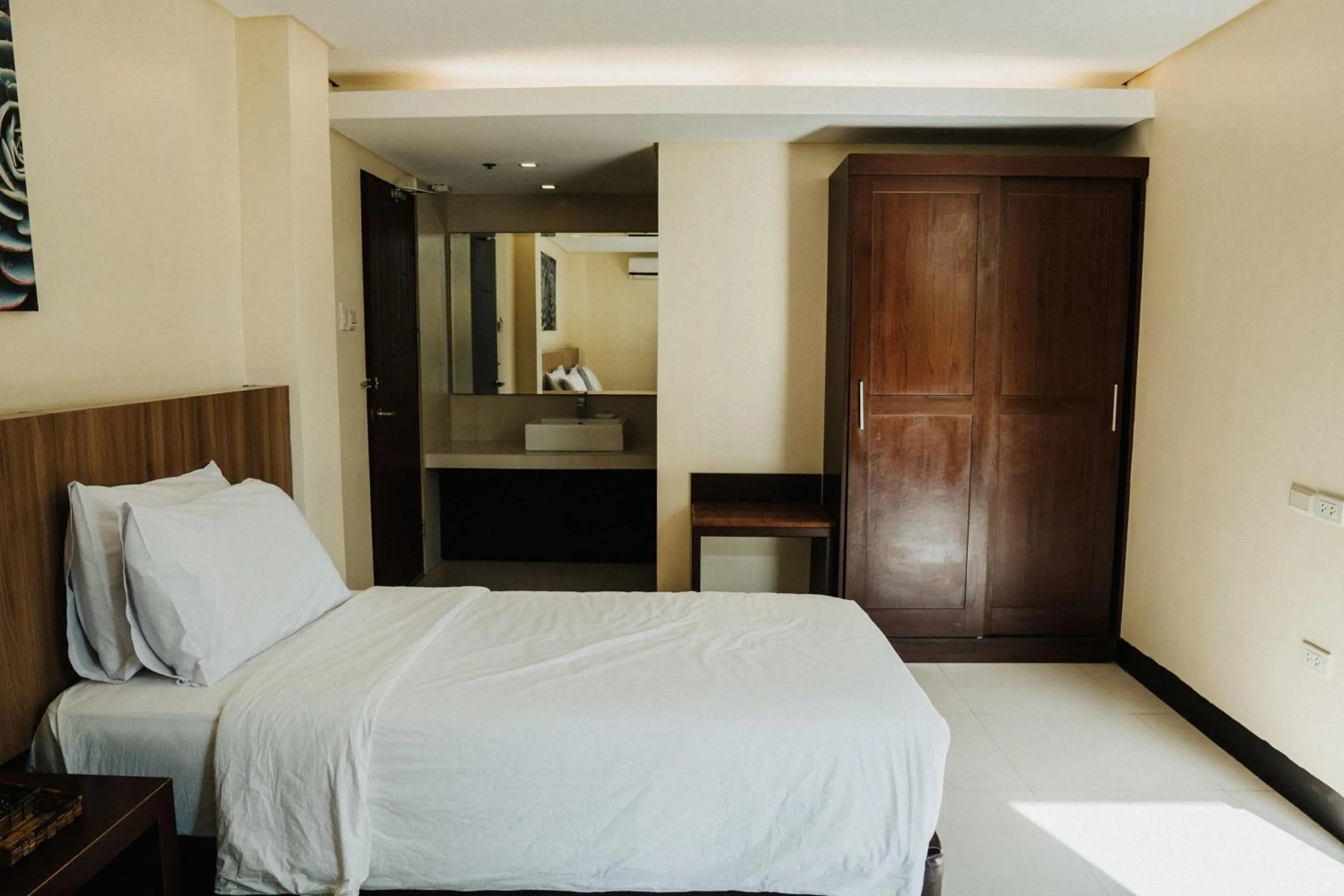 Bed in Ocean Suites Bohol Boutique Hotel