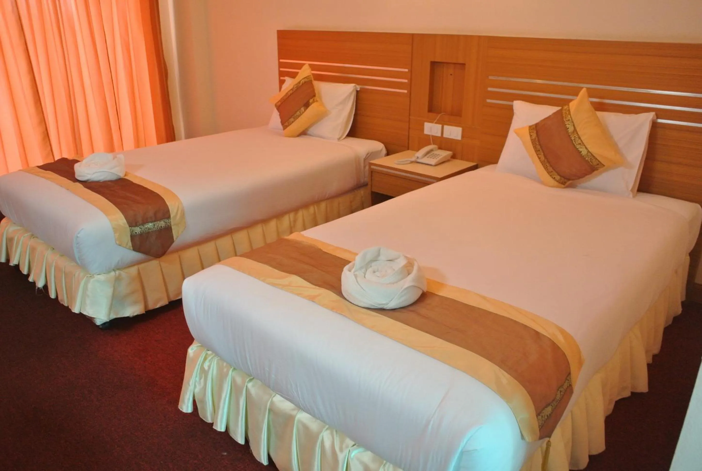 Bed in Chaikana Thani Hotel