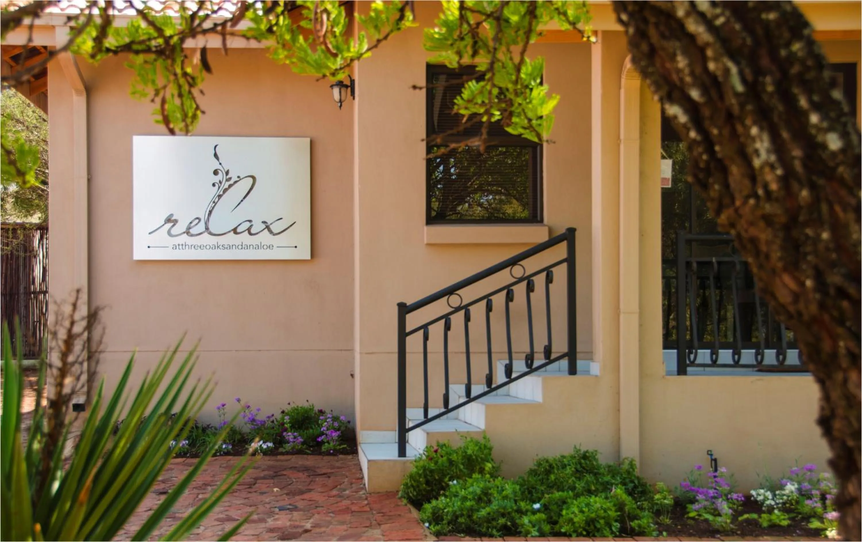 Property logo or sign in Three Oaks and an Aloe Boutique Hotel