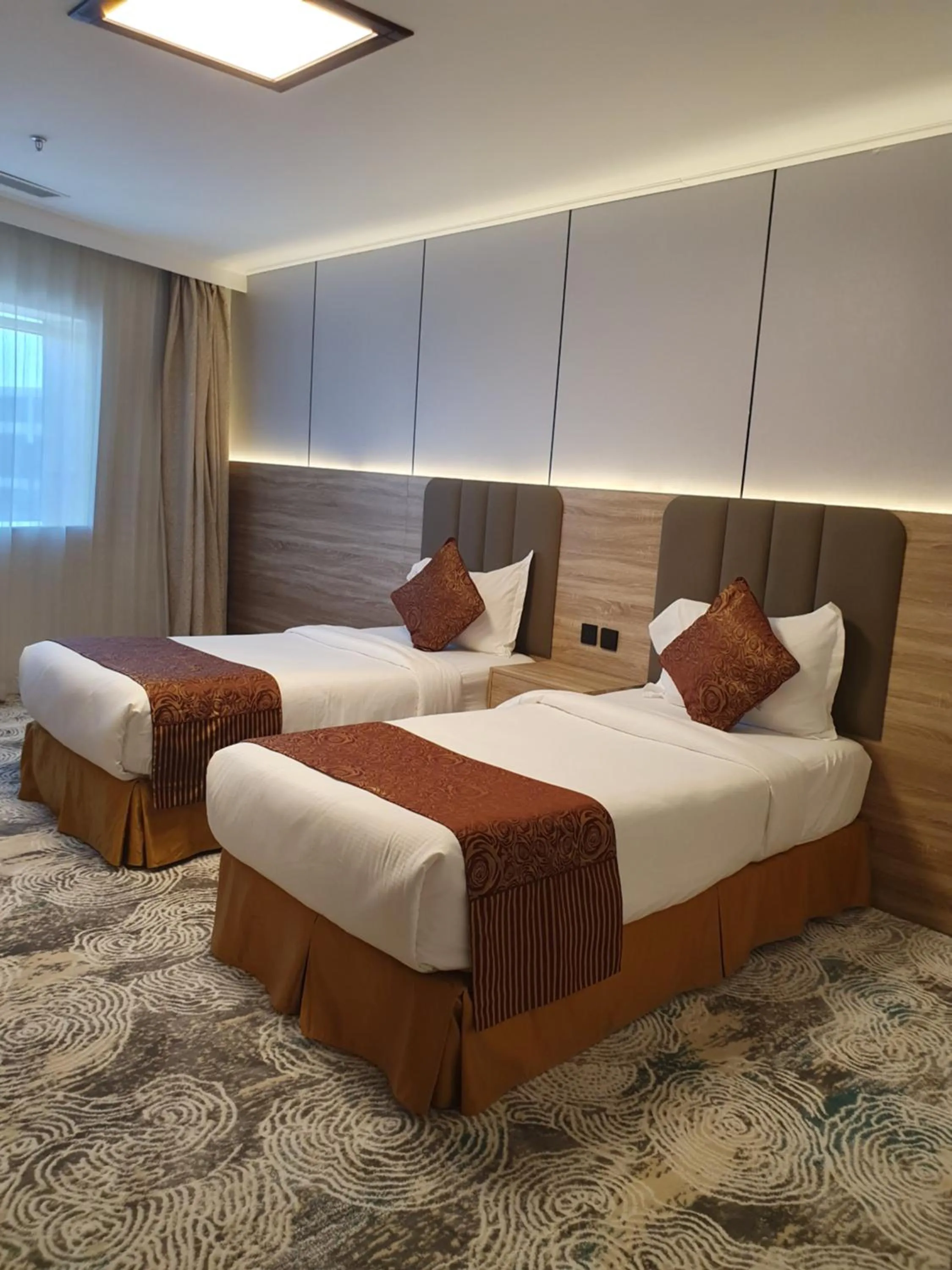 Bed in Sadeem Al Fajr Hotel Suites