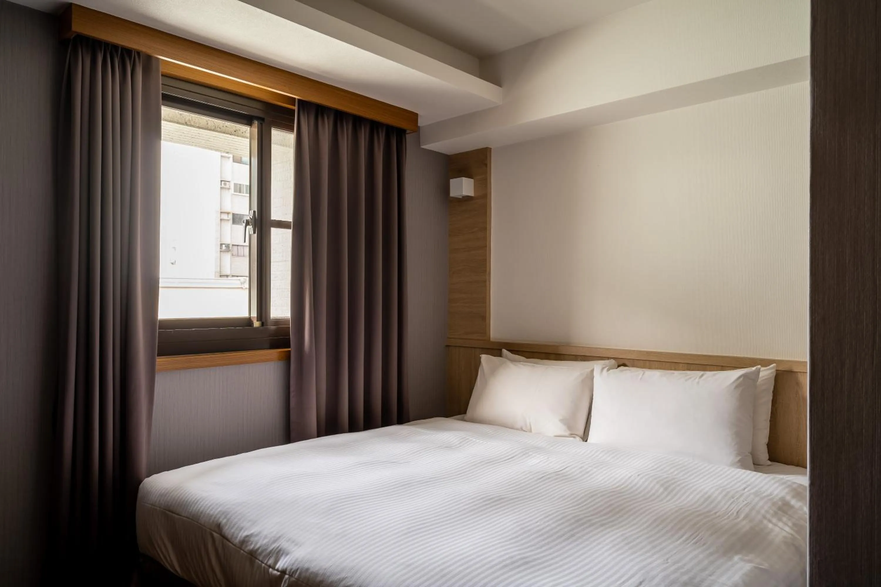 Bed in Global Traveler Hotel