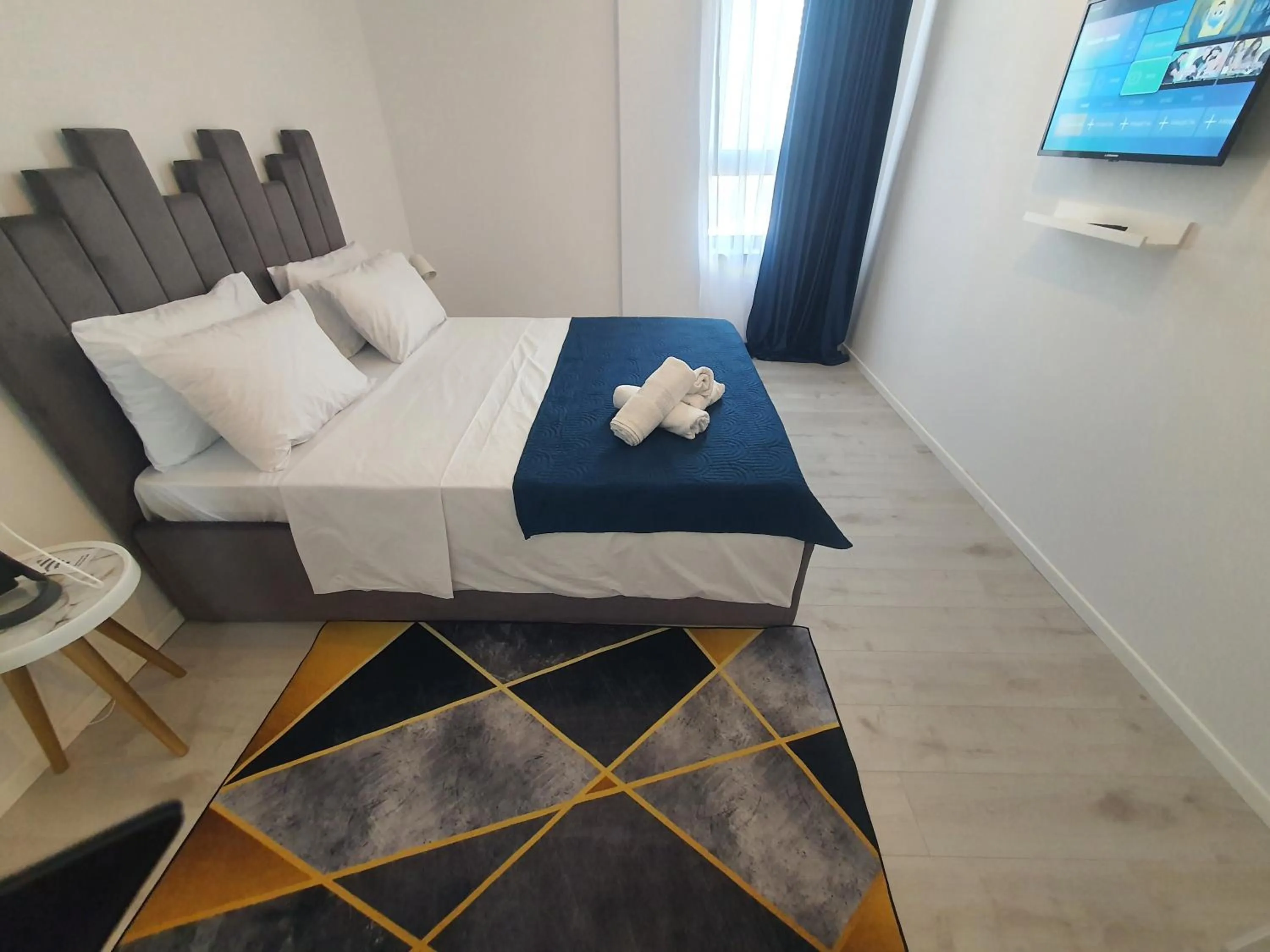 Bed in Grey Residence Apartments