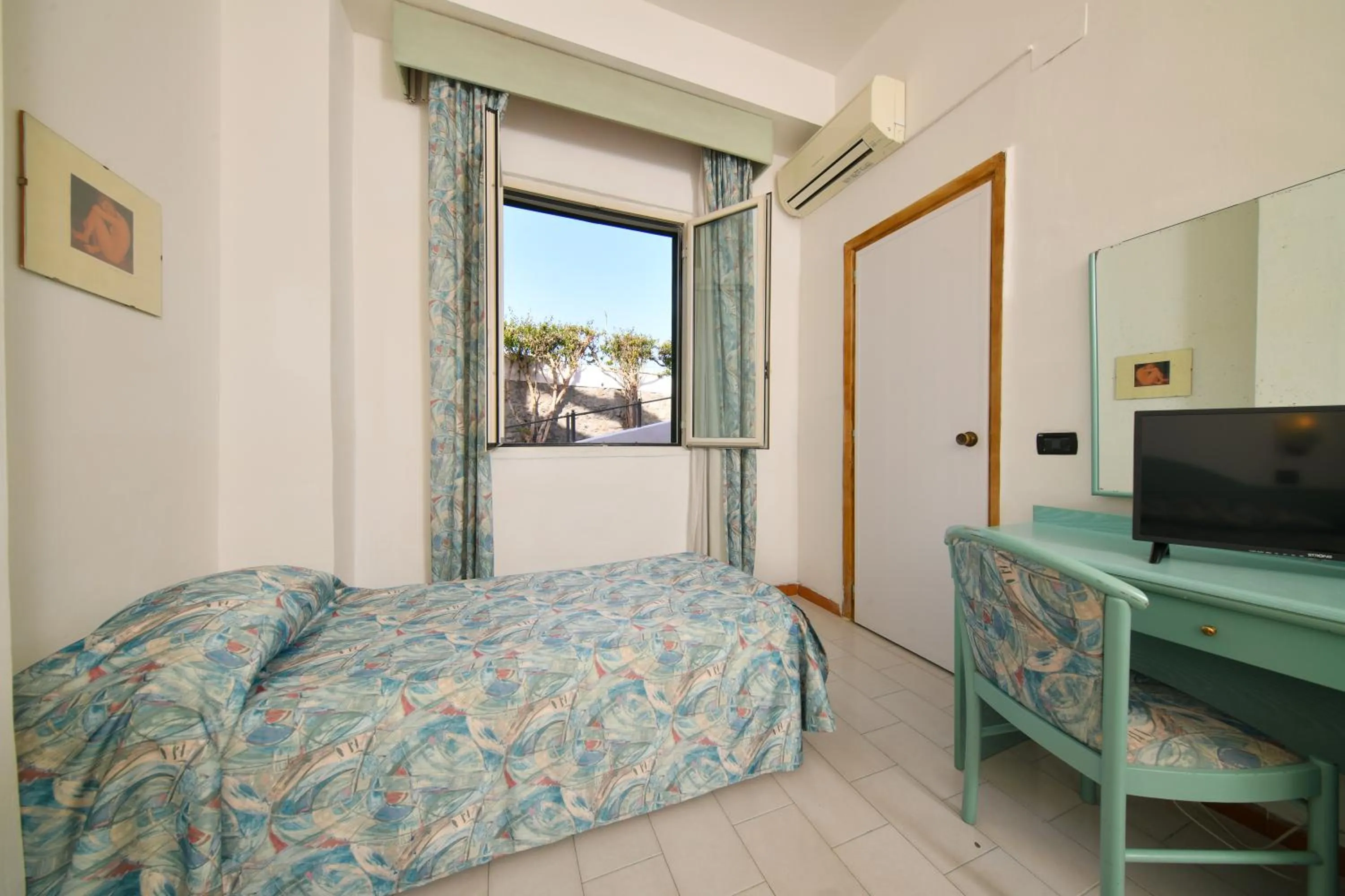 Photo of the whole room, TV/Entertainment Center in Fortuna Beach - Seaside Hotel