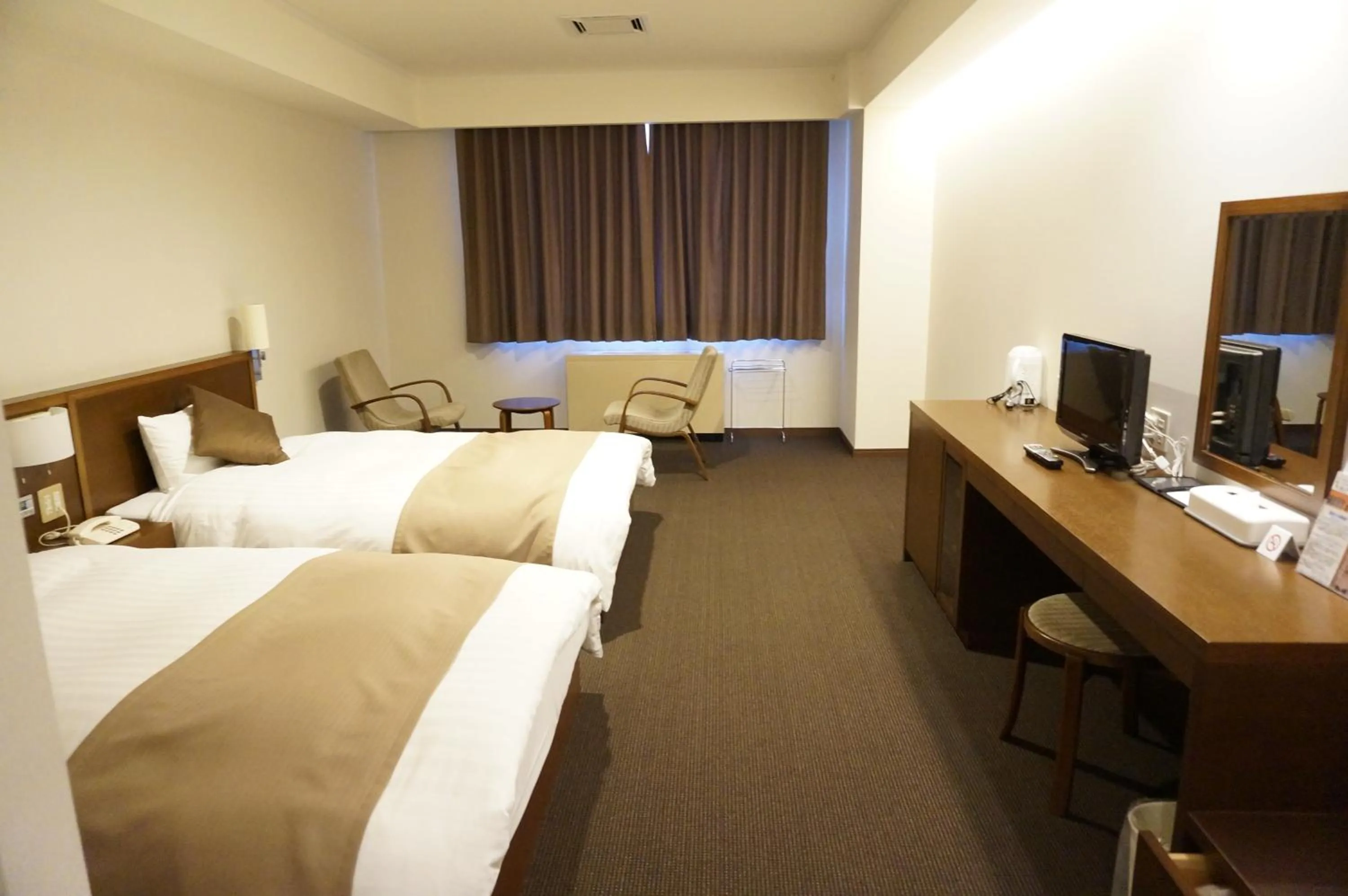 Bed in Kiyosato Onsen Hotel Ryokuseisou