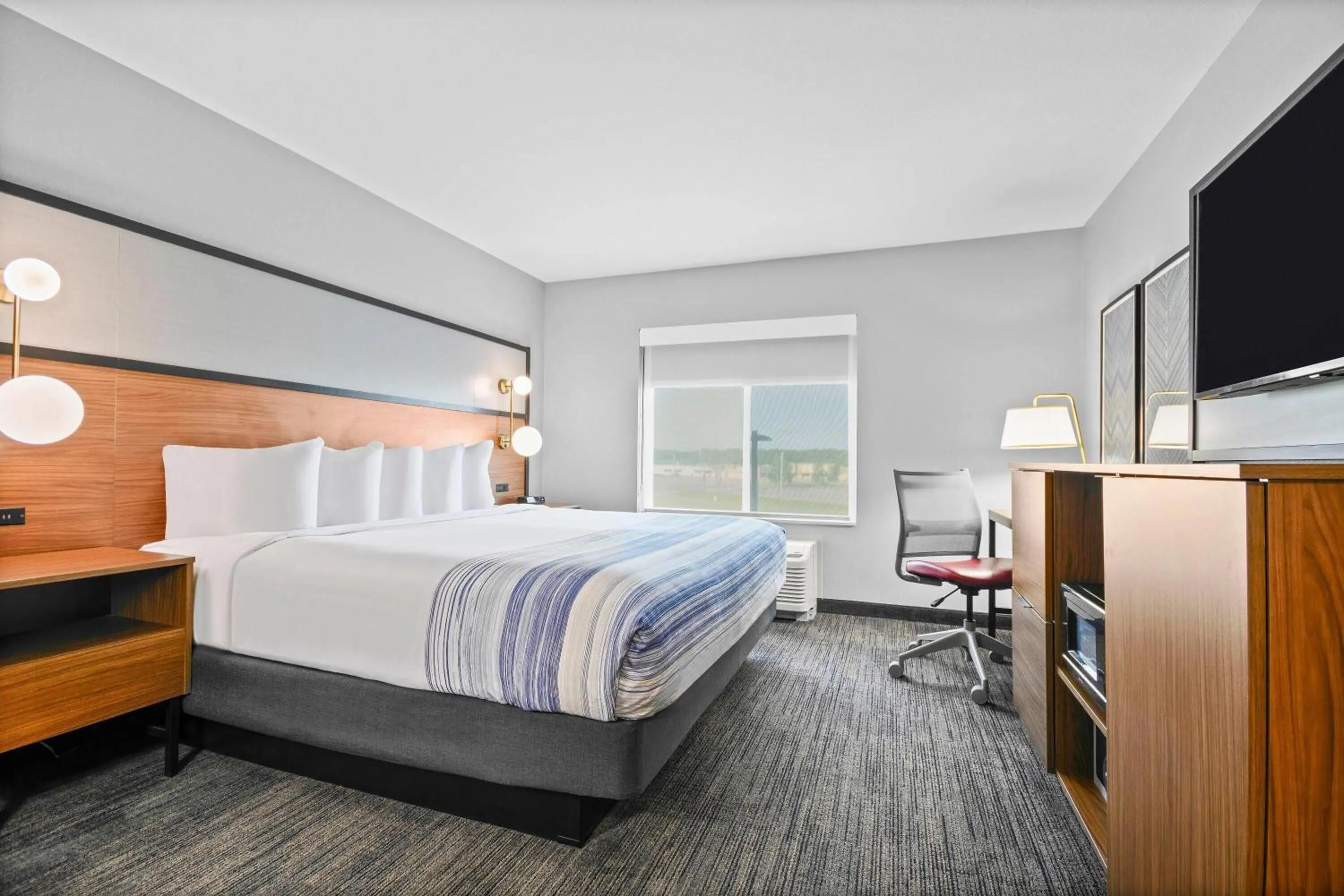 Bed in AmericInn by Wyndham International Falls