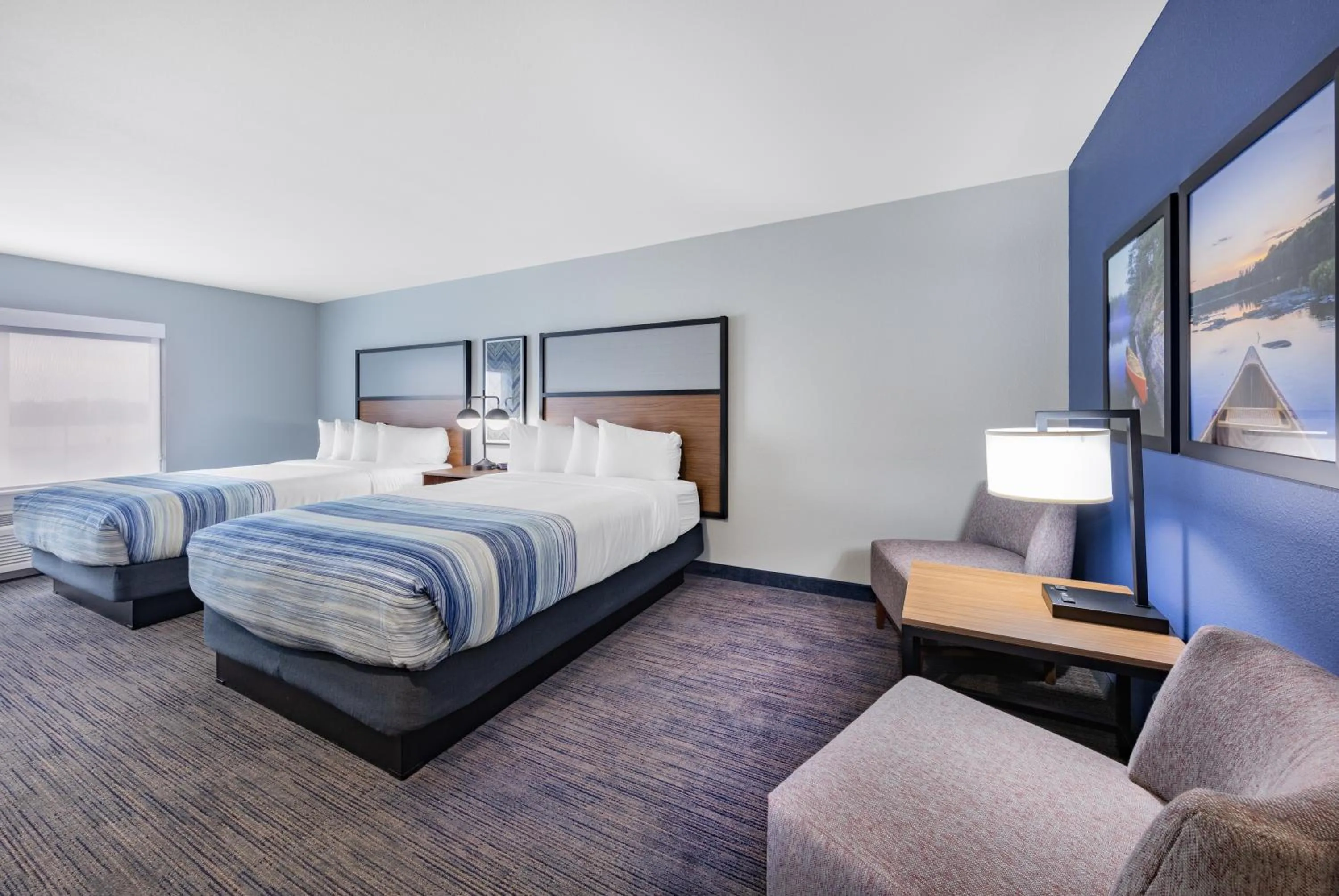 Seating area, Bed in AmericInn by Wyndham International Falls