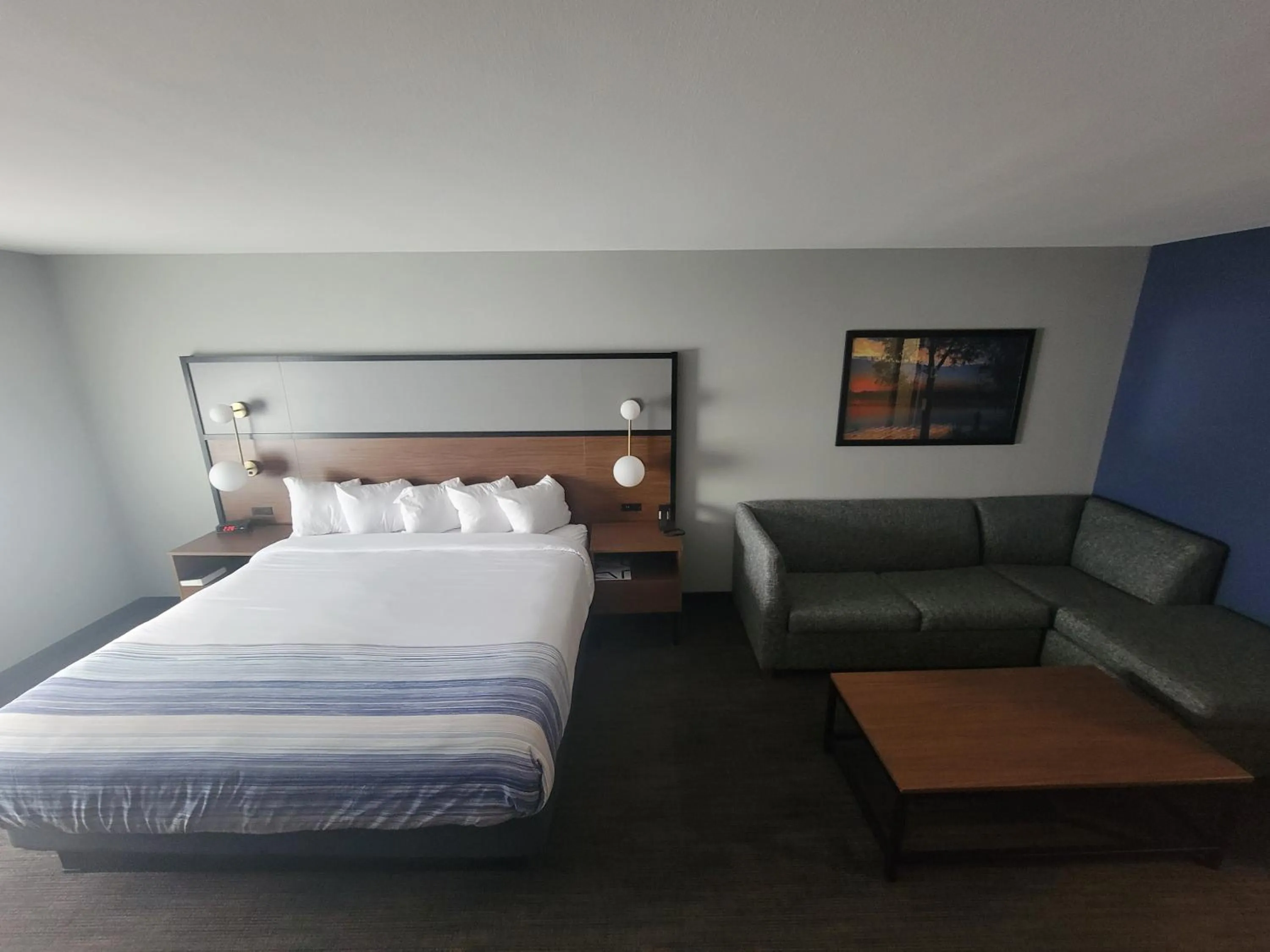 Seating area, Bed in AmericInn by Wyndham International Falls