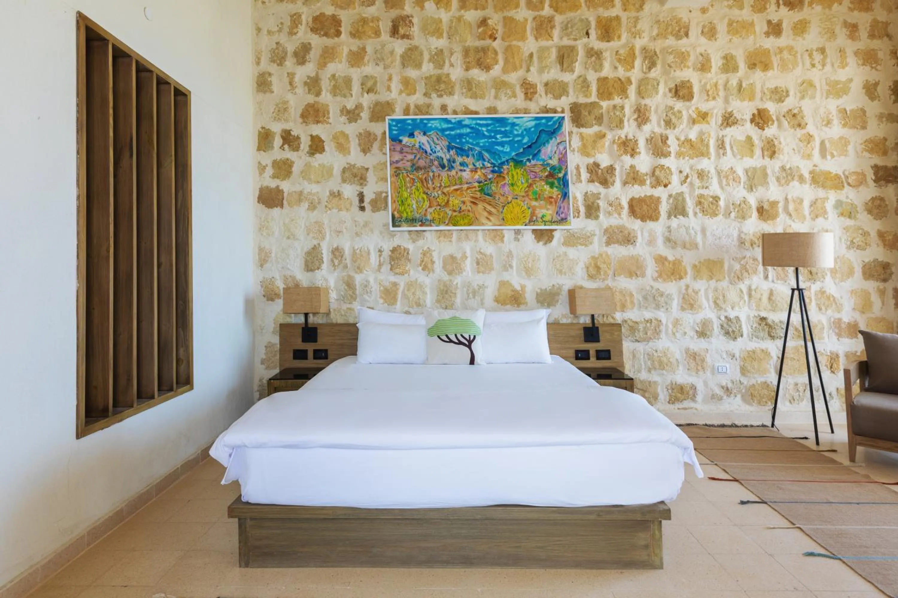 Bed in Wadi Sabarah Lodge