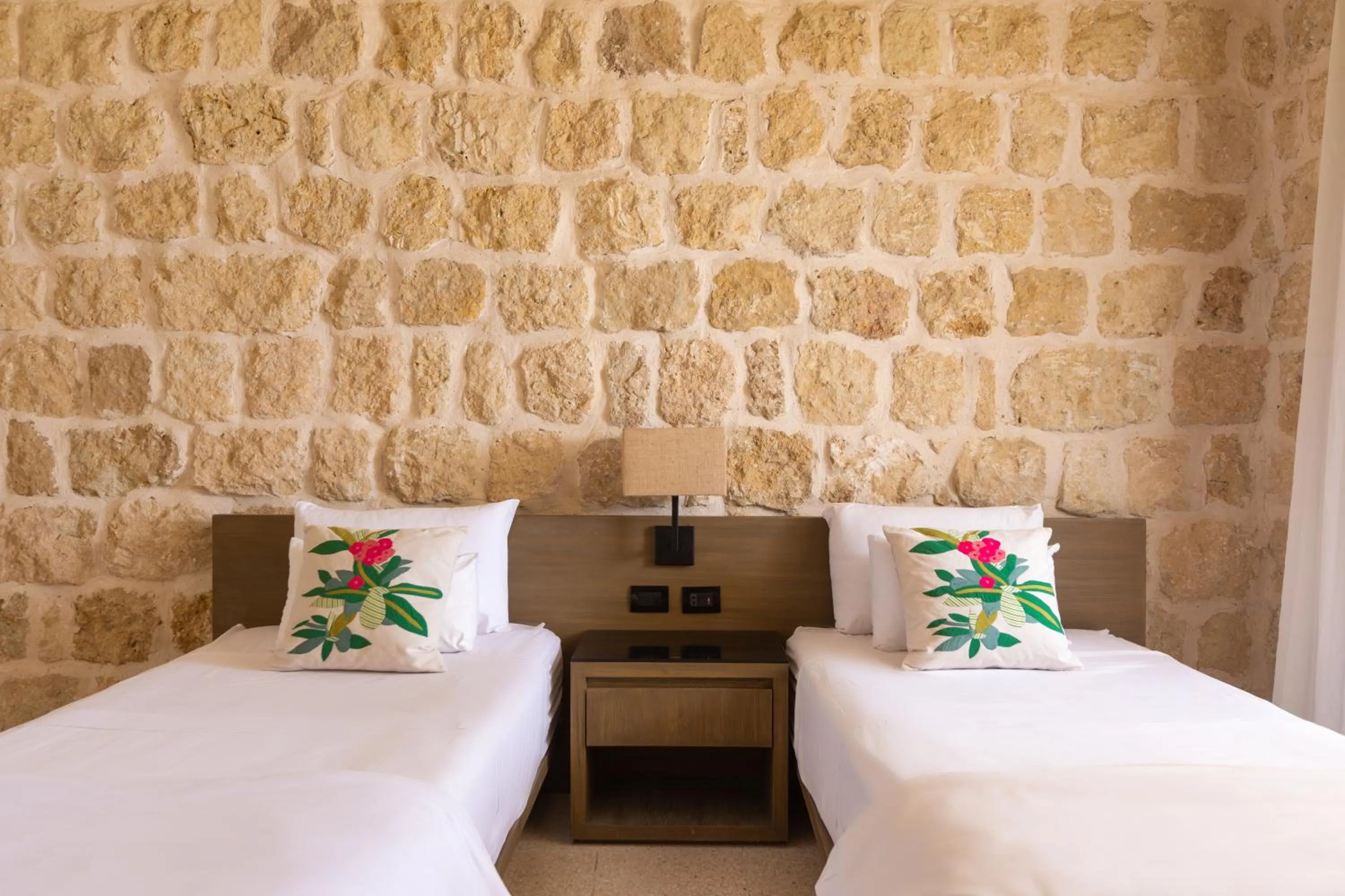 Bed in Wadi Sabarah Lodge