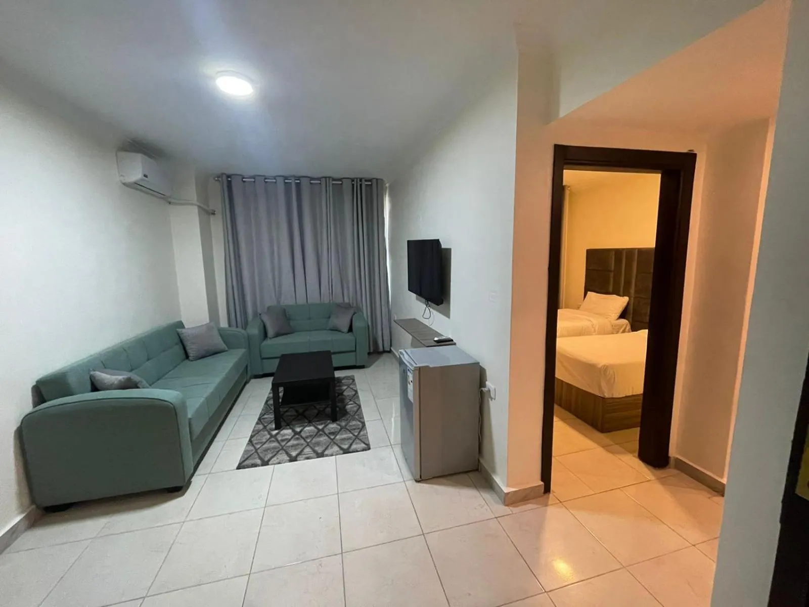 Communal lounge/ TV room, Bed in Golden Hotel