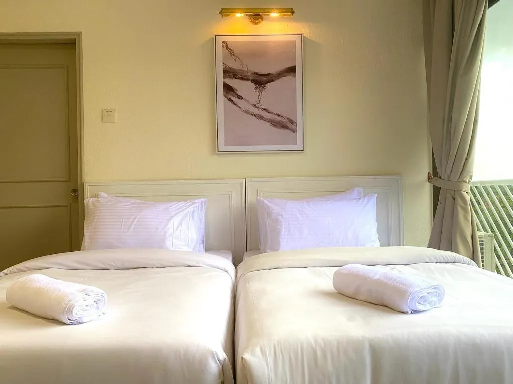 Bed in SWISS AVENUE HOTEL