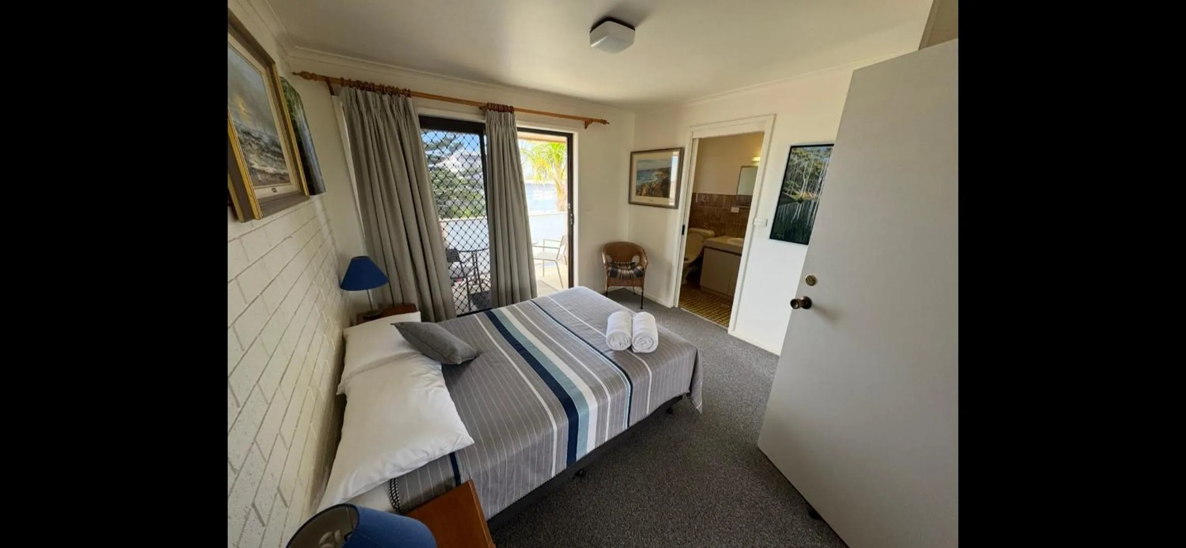 Bed in Narooma Palms Holiday Apartments