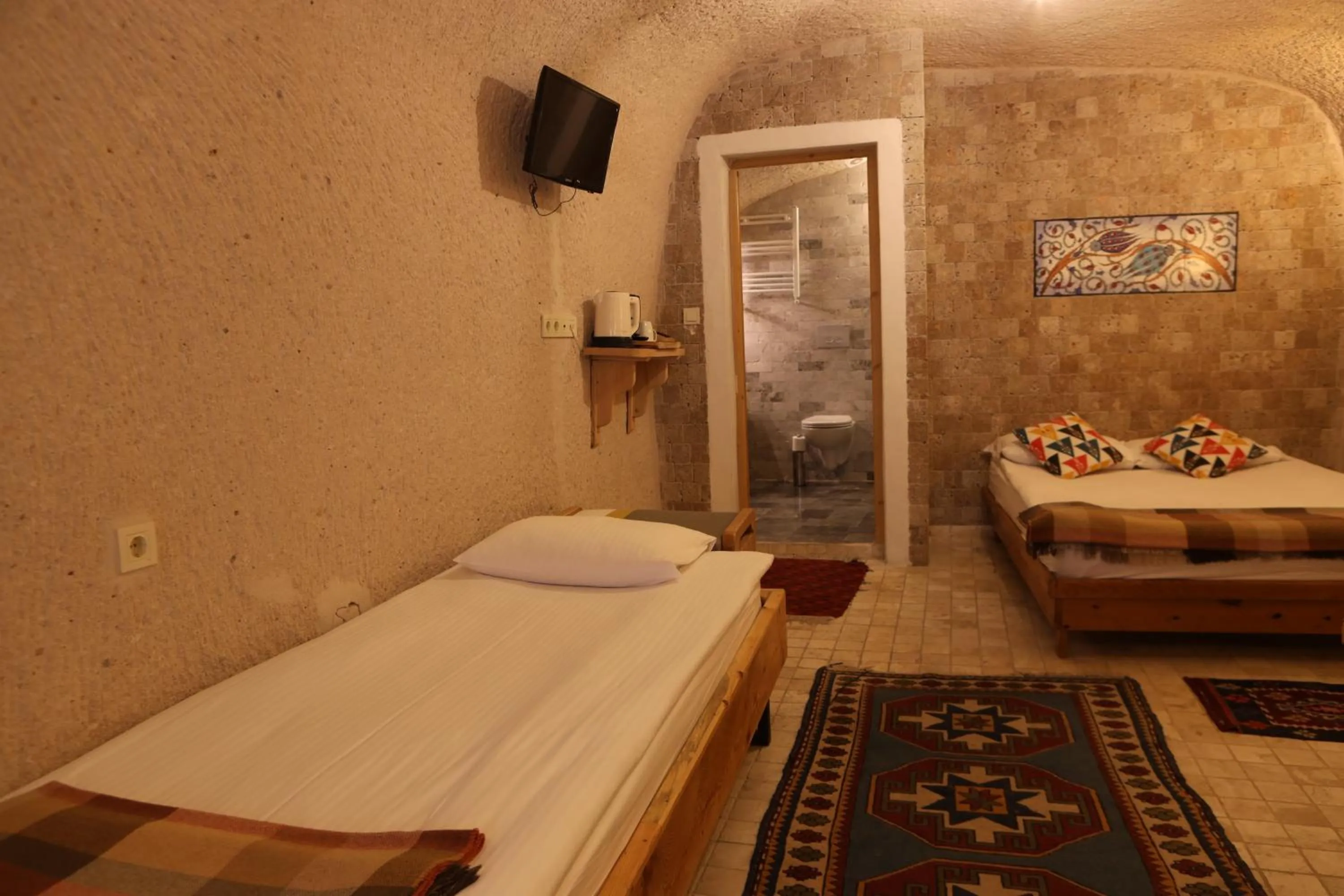 Bed in Pinhan Cave Suites