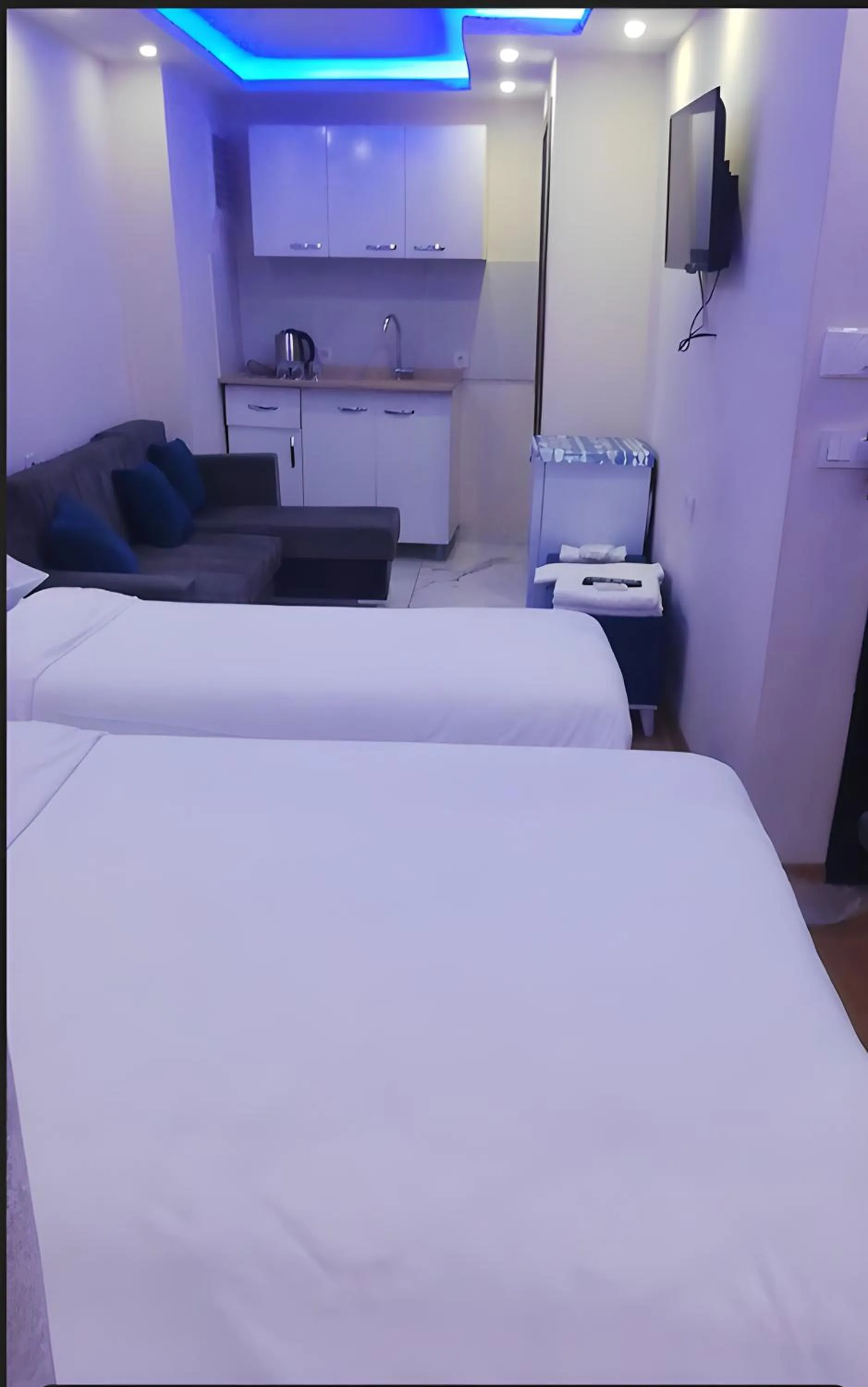 Kitchen or kitchenette, Bed in BLUE ROYAL HOTEL