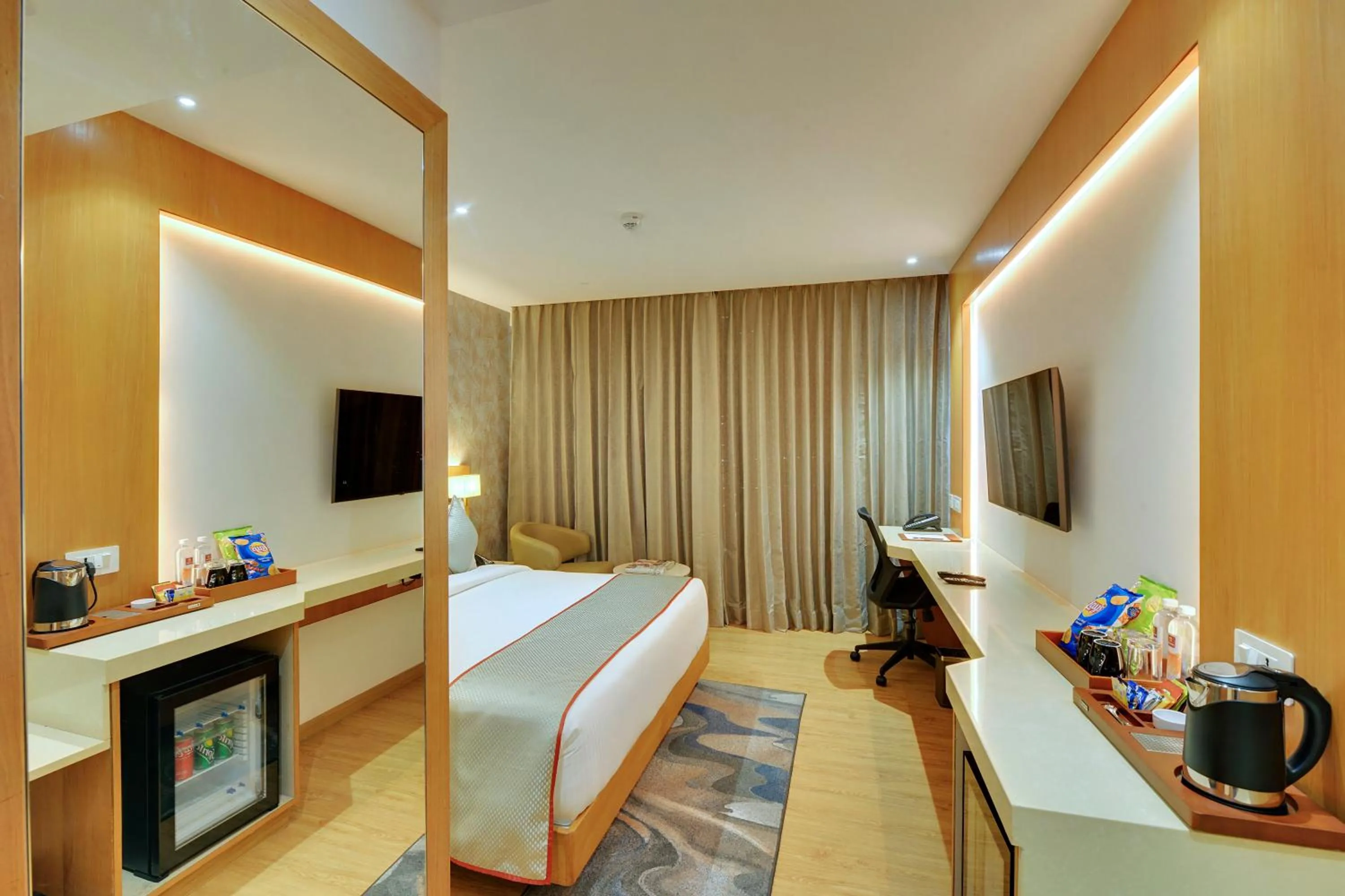 Seating area, Bed in Clarion Hotel Bangalore