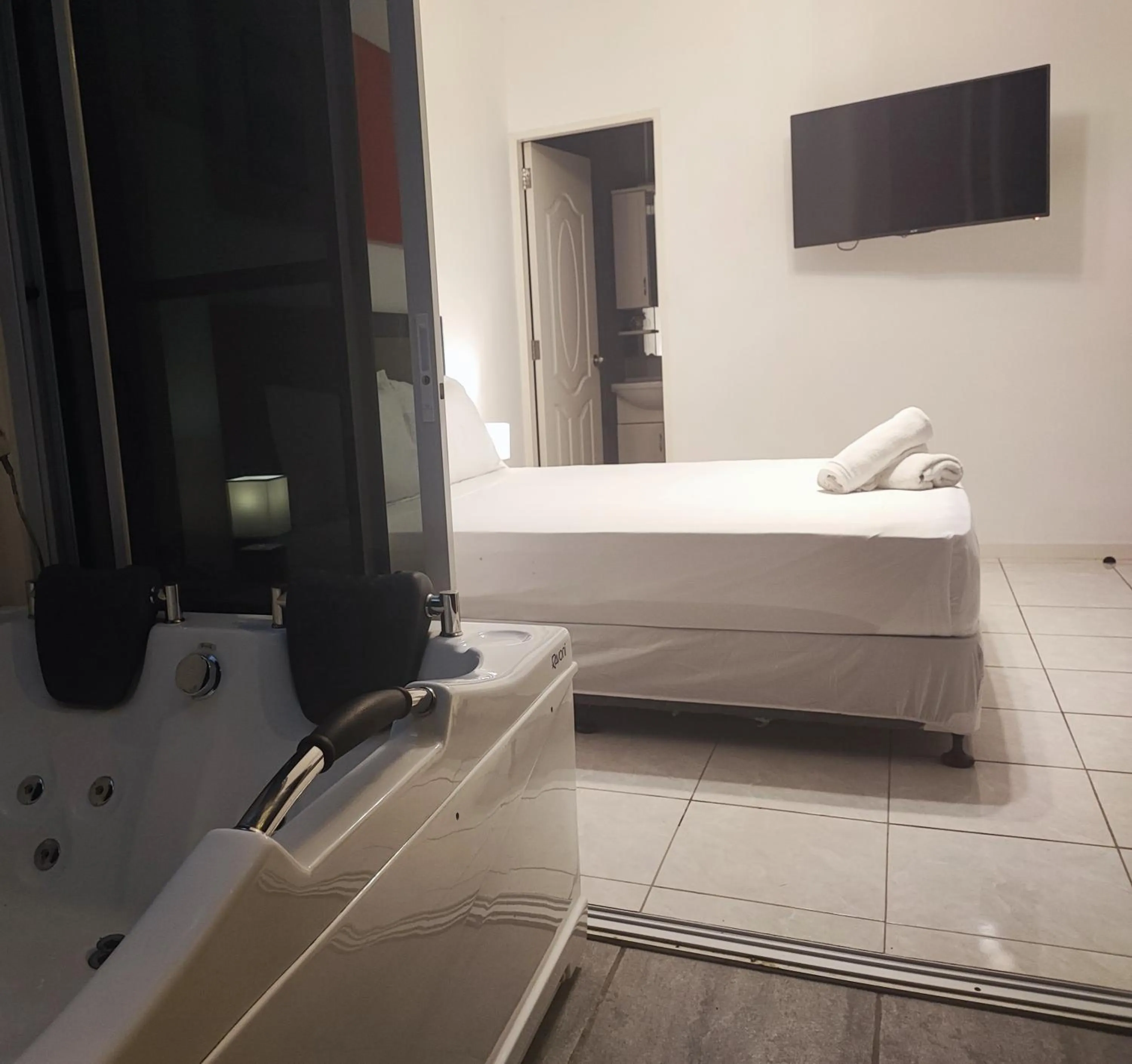 Bed in Bonsai Jacuzzi Suites