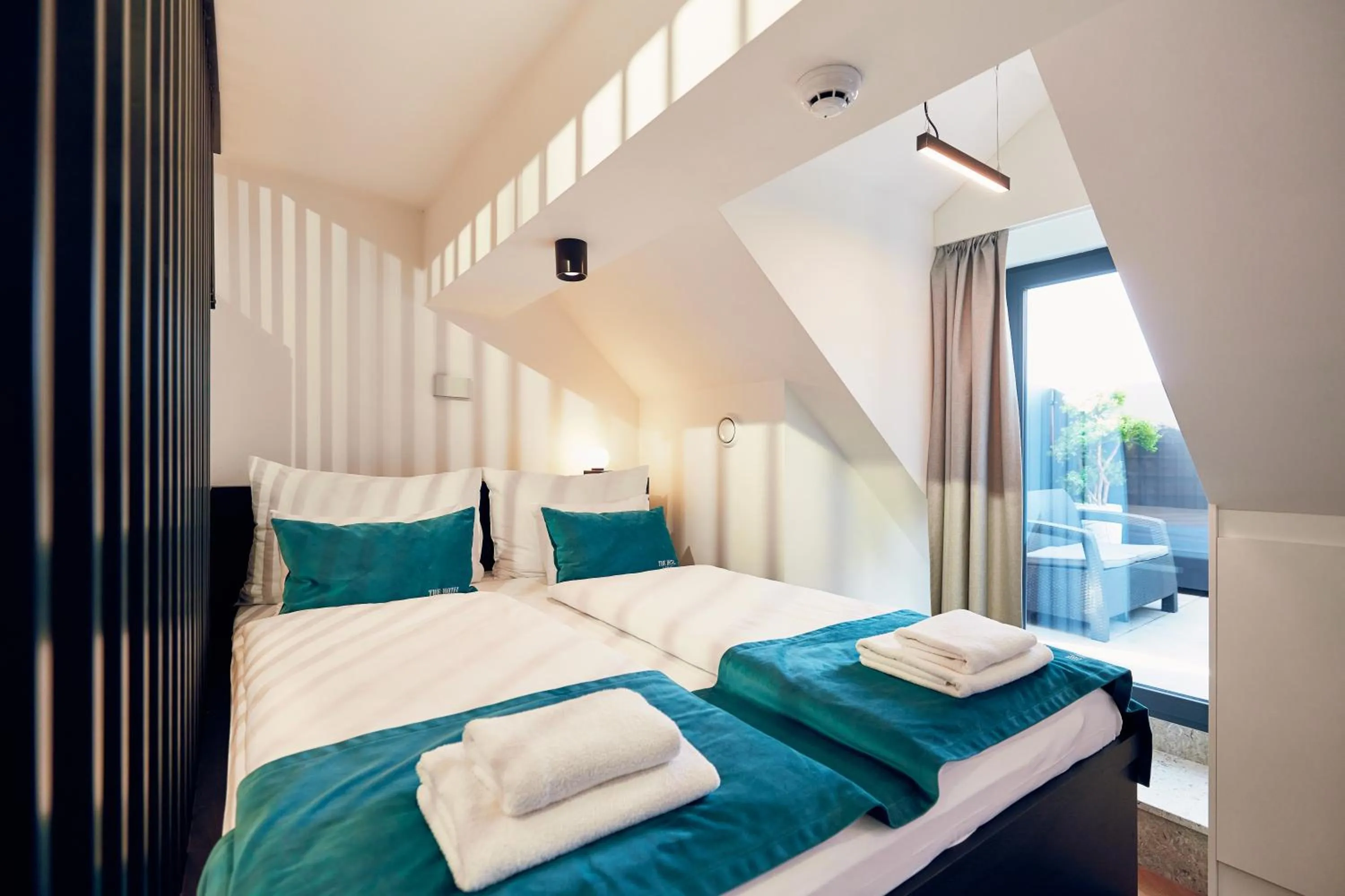 Bed in The Hotel Ljubljana