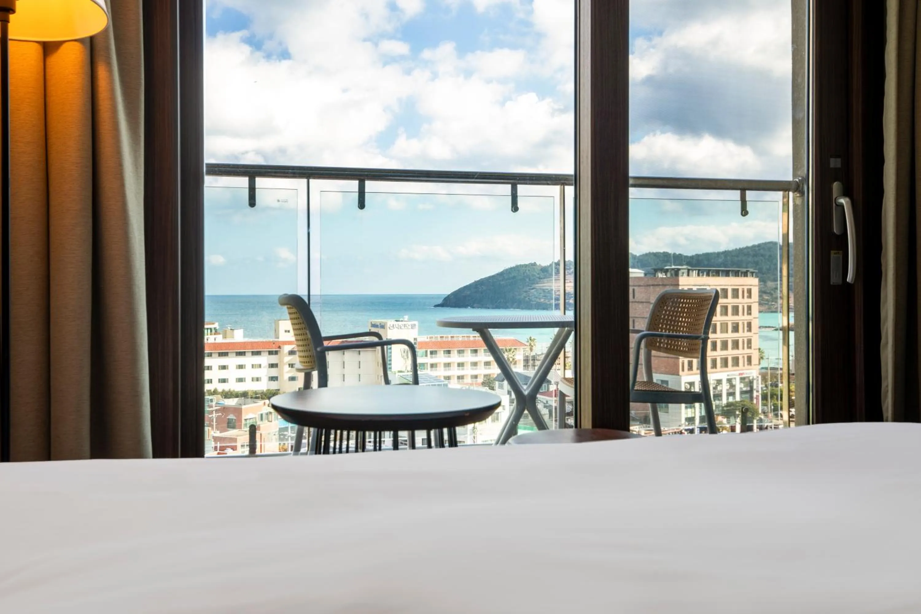 Bed in Ramada by Wyndham Jeju Hamdeok