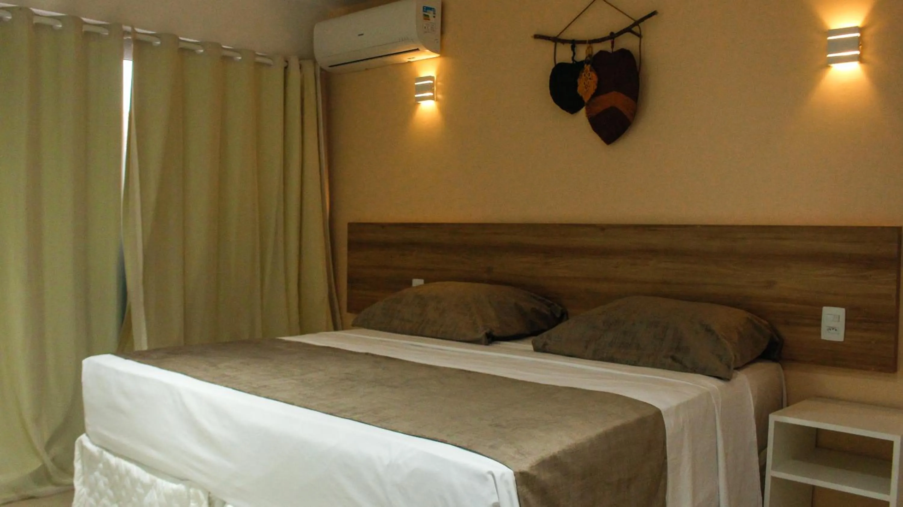 Bed in Pousada Jardins Tropical