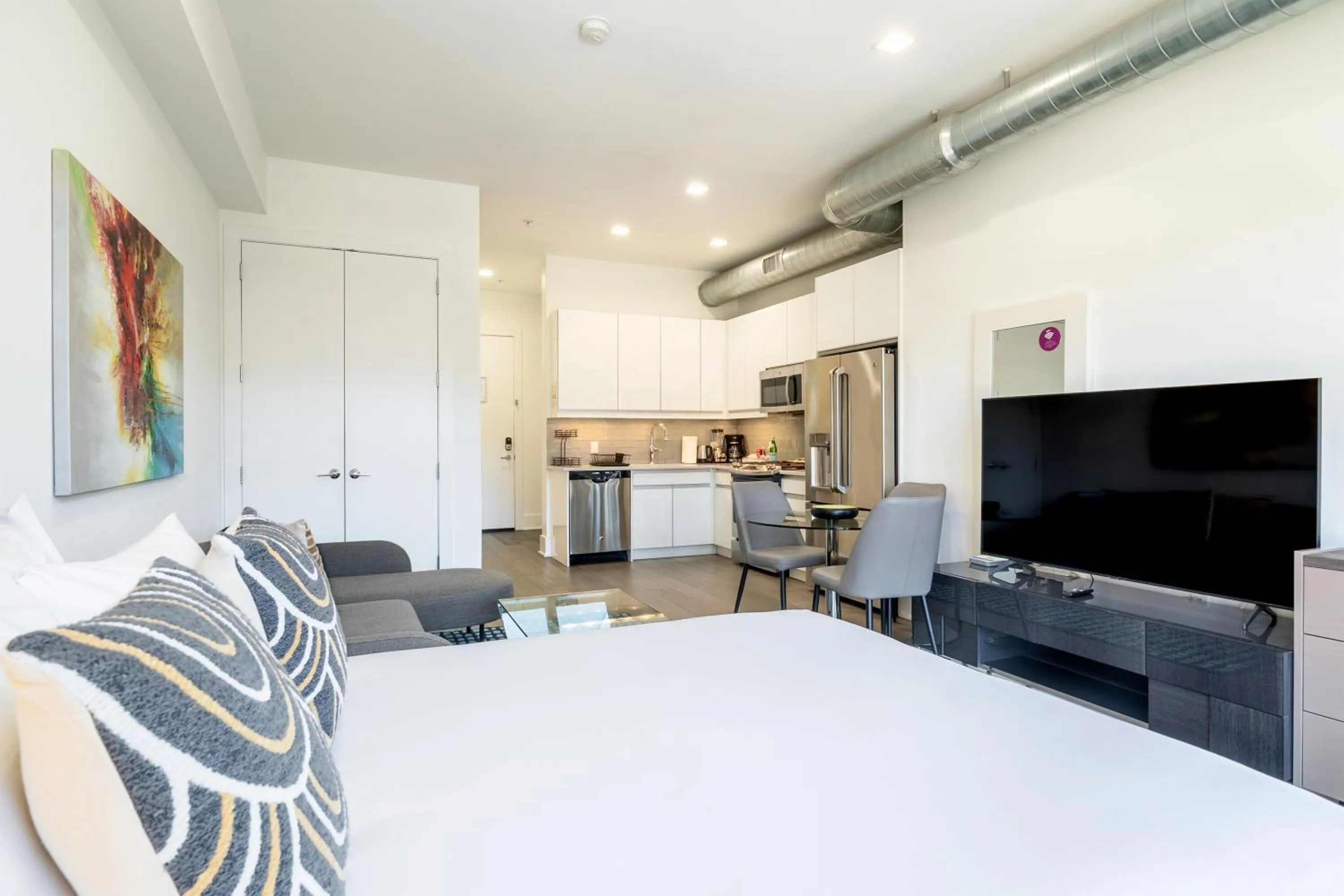Living room, Bed in Dharma Home Suites Hoboken