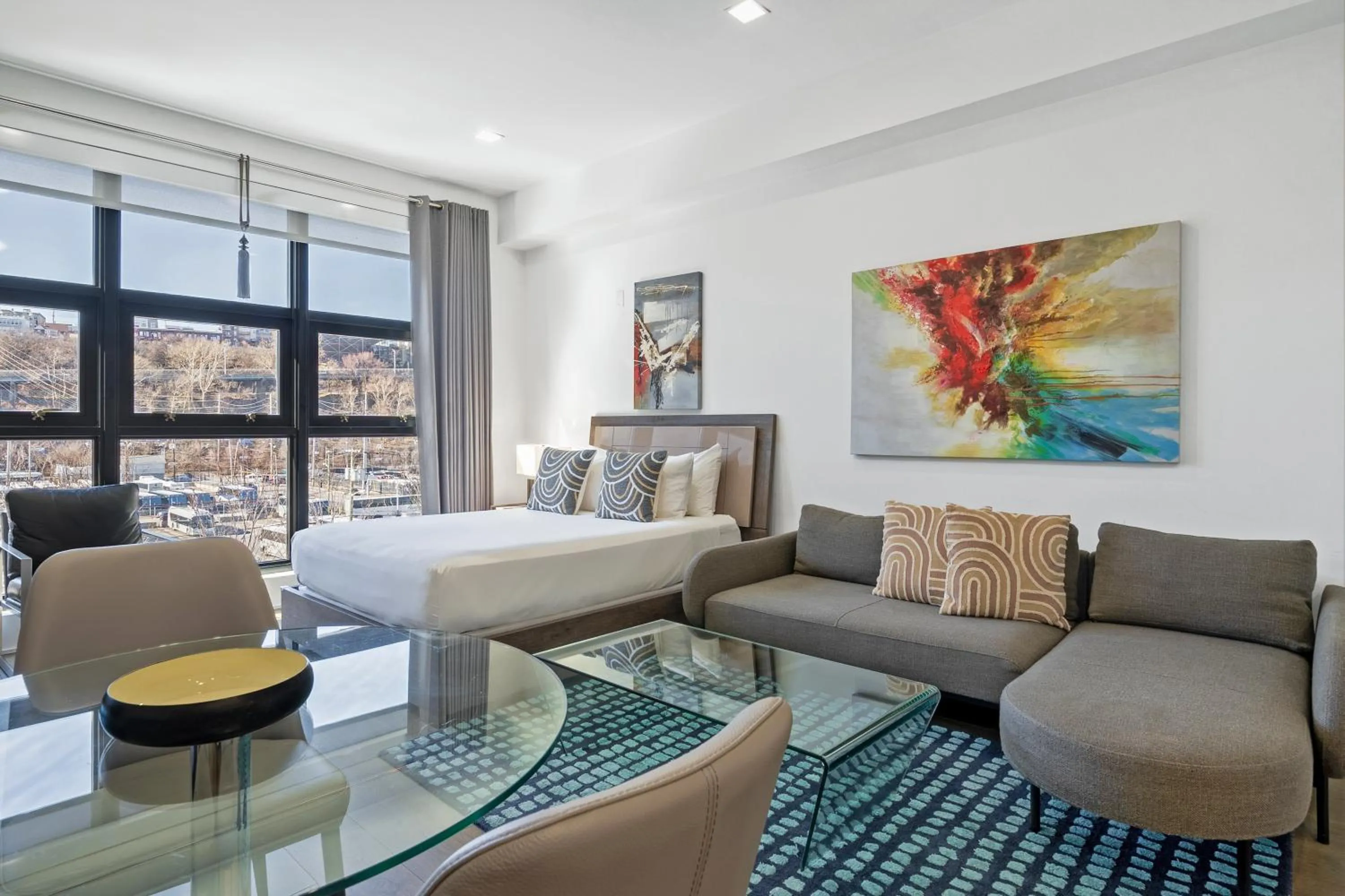 Living room, Bed in Dharma Home Suites Hoboken