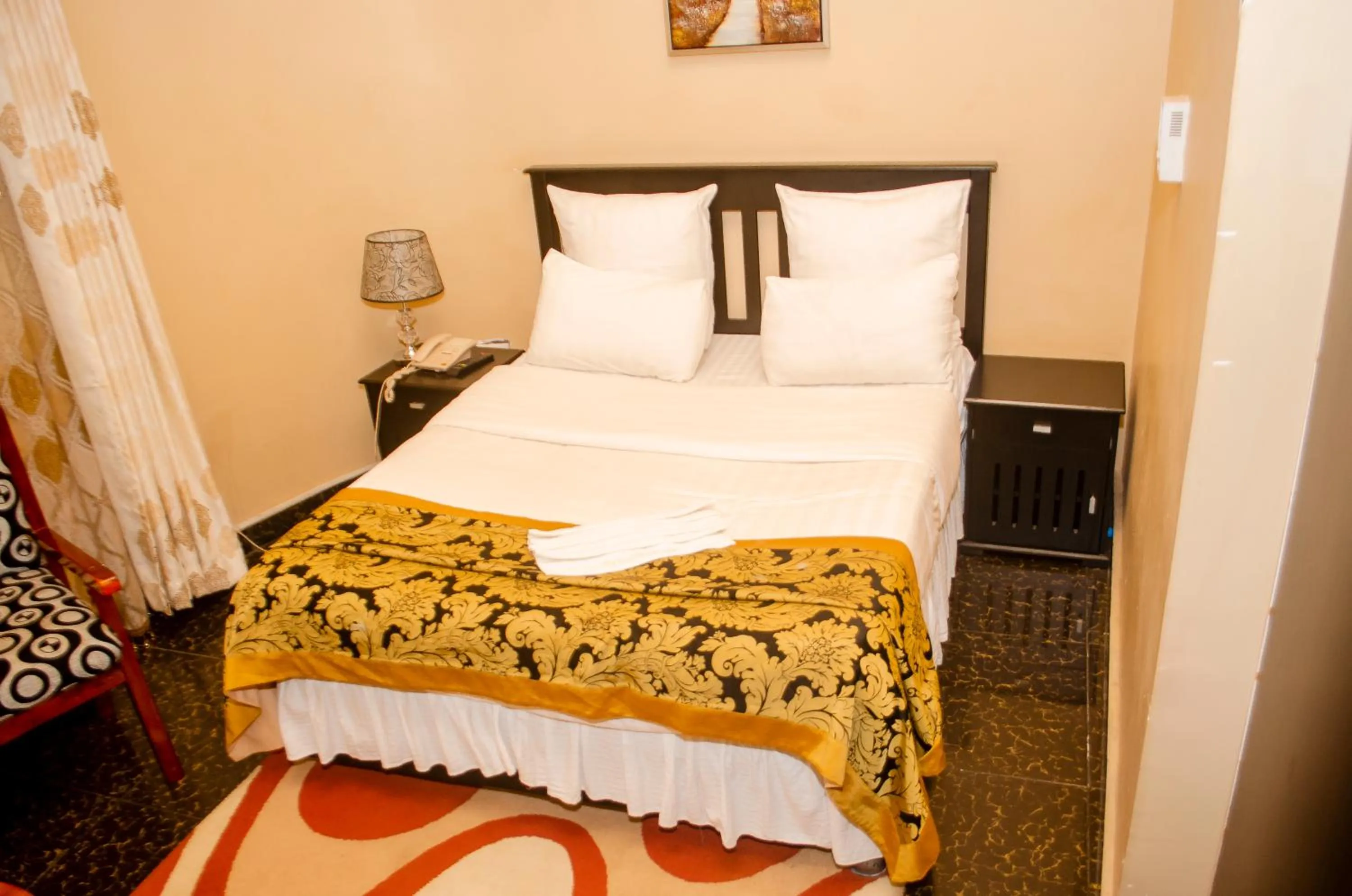 Bed in ROYAL SHALOM HOTEL