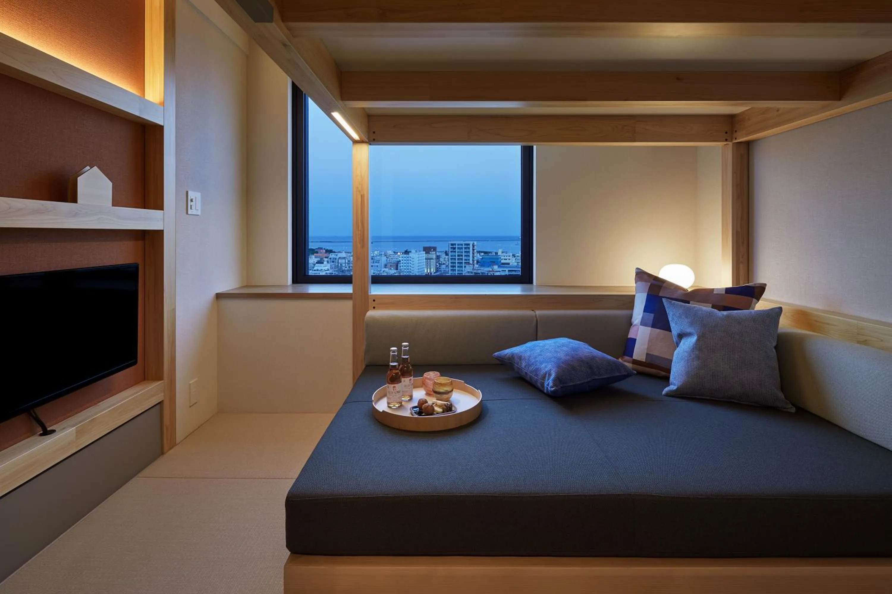 Living room, Bed in OMO5 Okinawa Naha by Hoshino Resorts