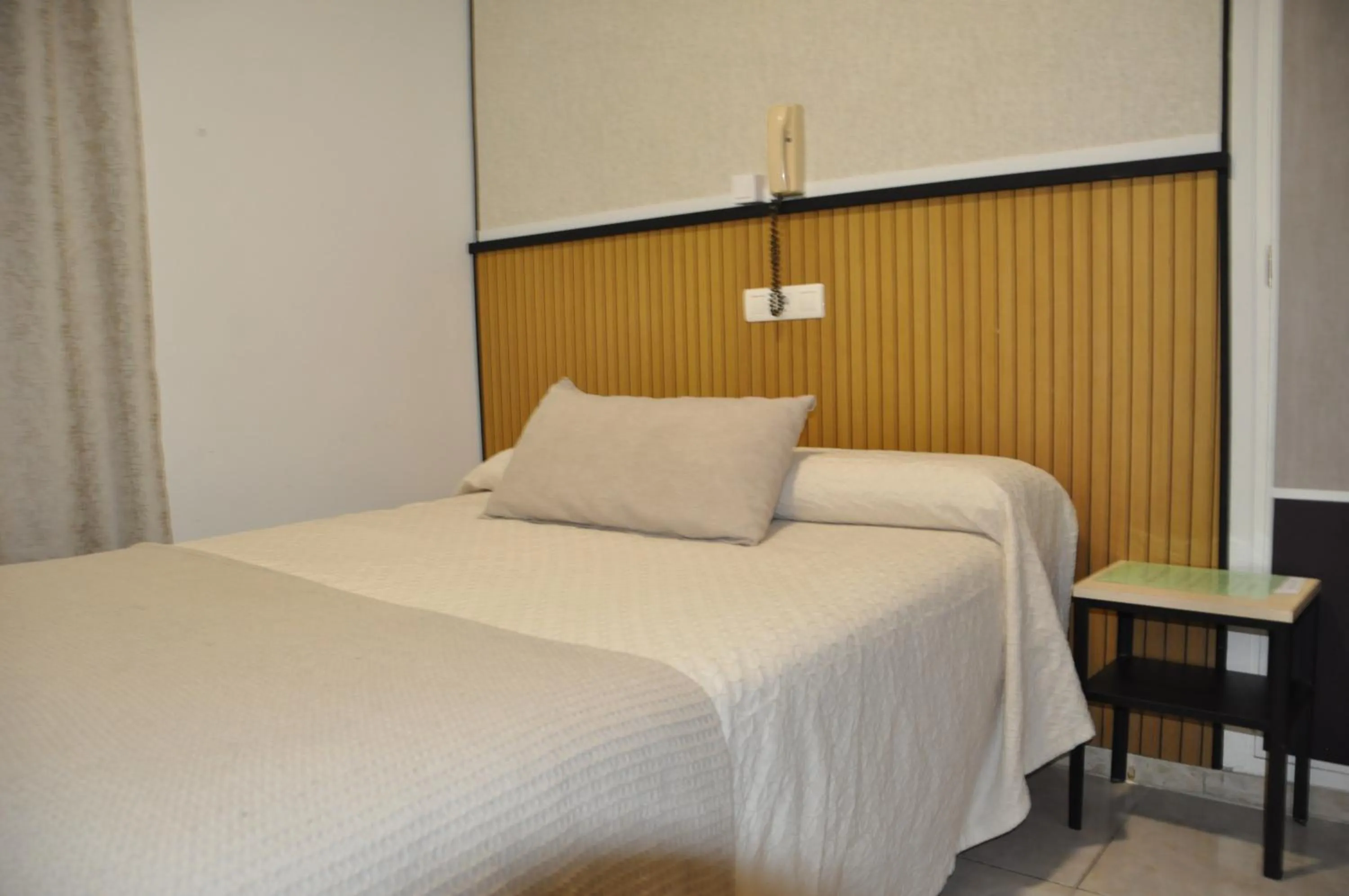 Bed in Hostal Ramón y Cajal