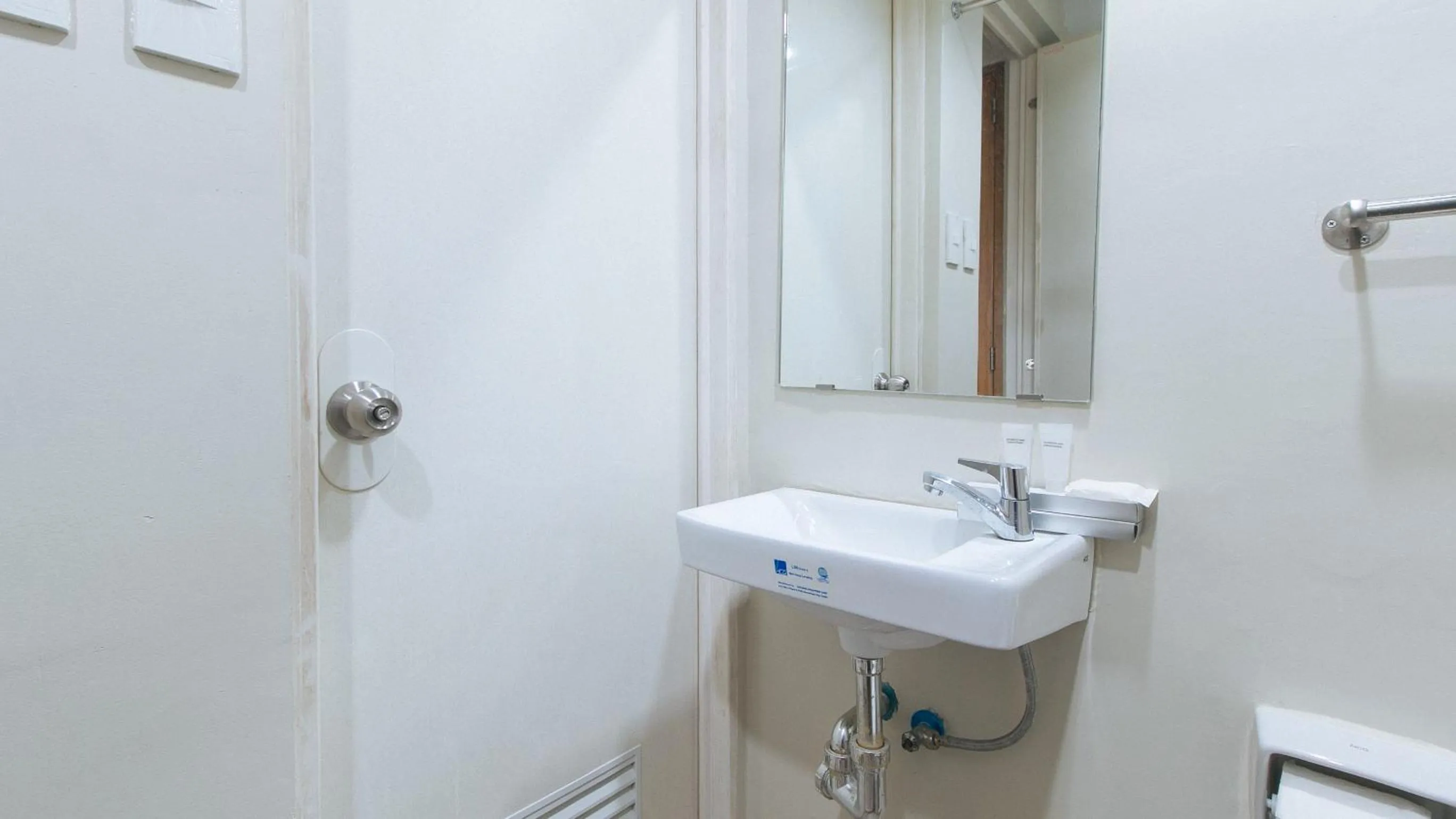 Bathroom in Filmore Suites Makati by RedDoorz