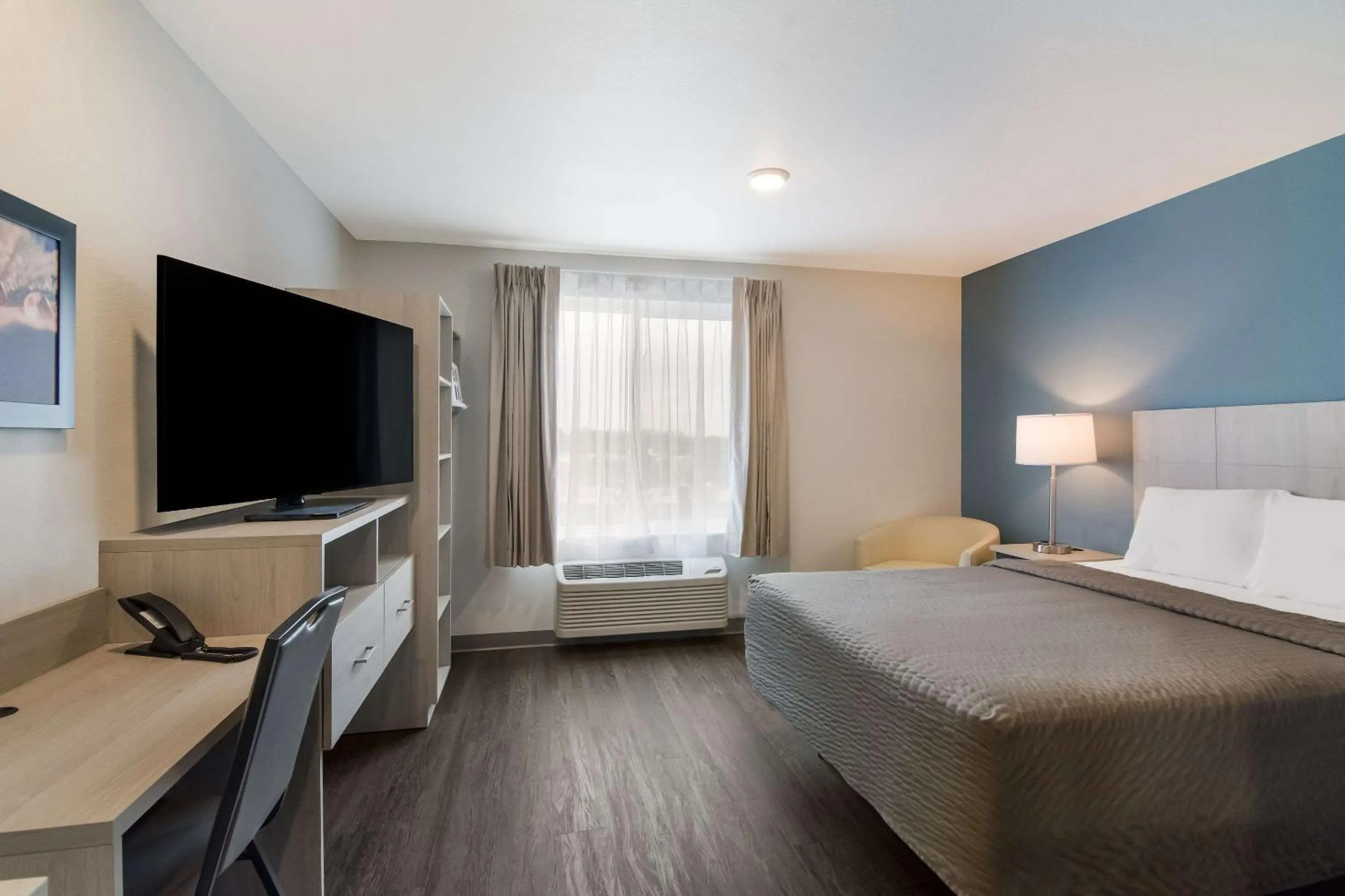 TV and multimedia, Bed in WoodSpring Suites Morrisville - Raleigh Durham Airport