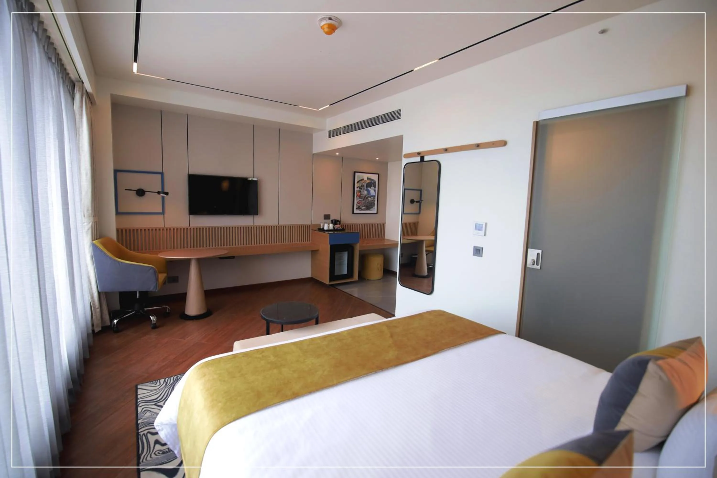 Photo of the whole room, Bed in Ramada Encore by Wyndham Siliguri Sevoke Road