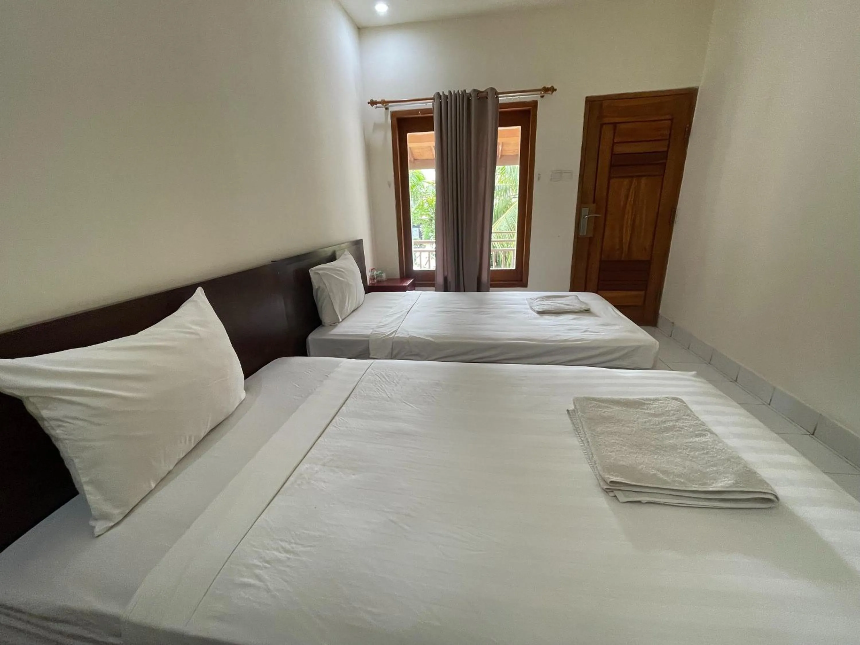 Bed in Melati Resort & Hotel Kuta Lombok