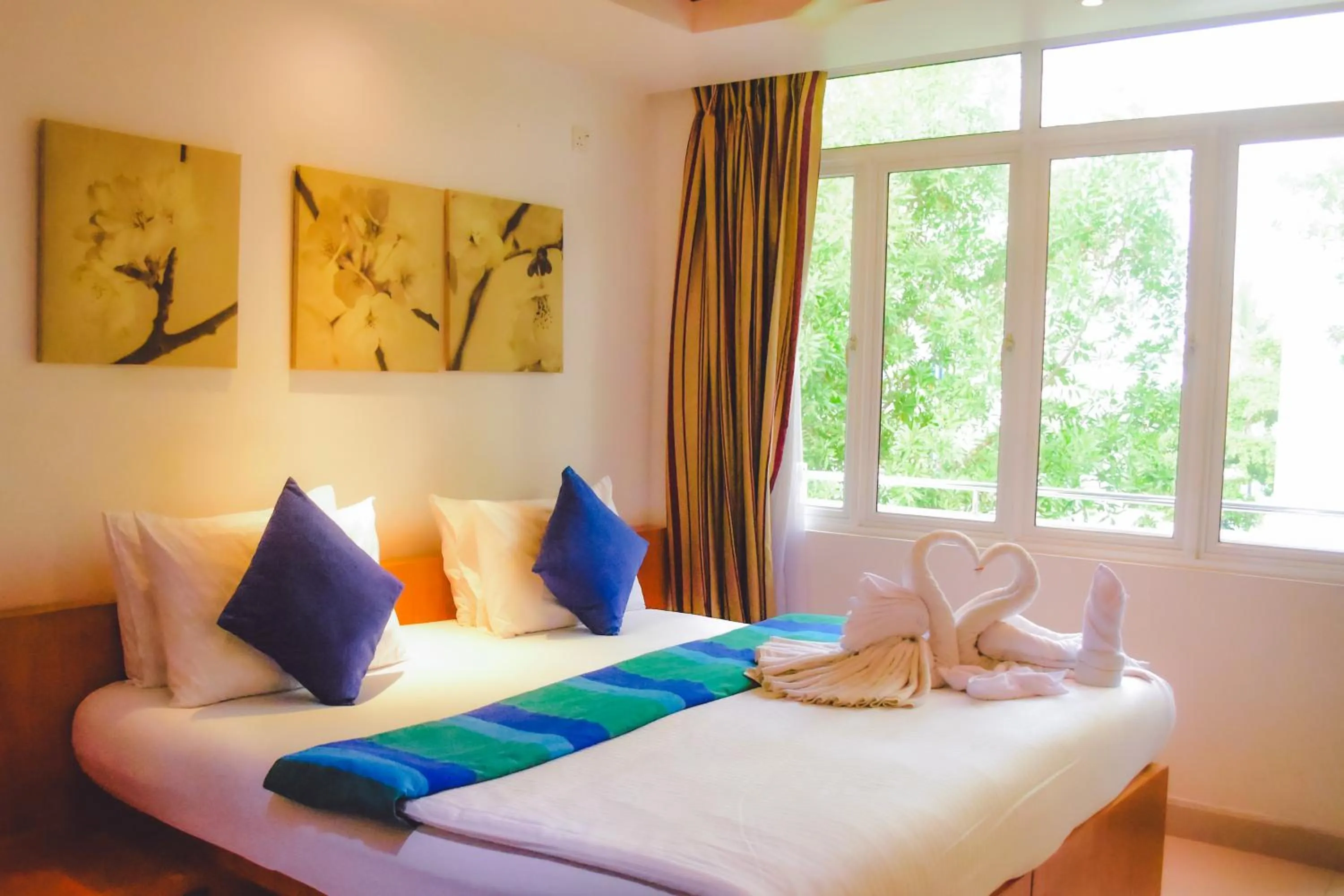 Bed in PINE LODGE MALDIVES