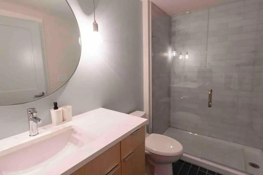 Shower in Spacious 1 bed 1 bath Downtown OTR condo minutes walk to the Reds Bengals stadium & more!