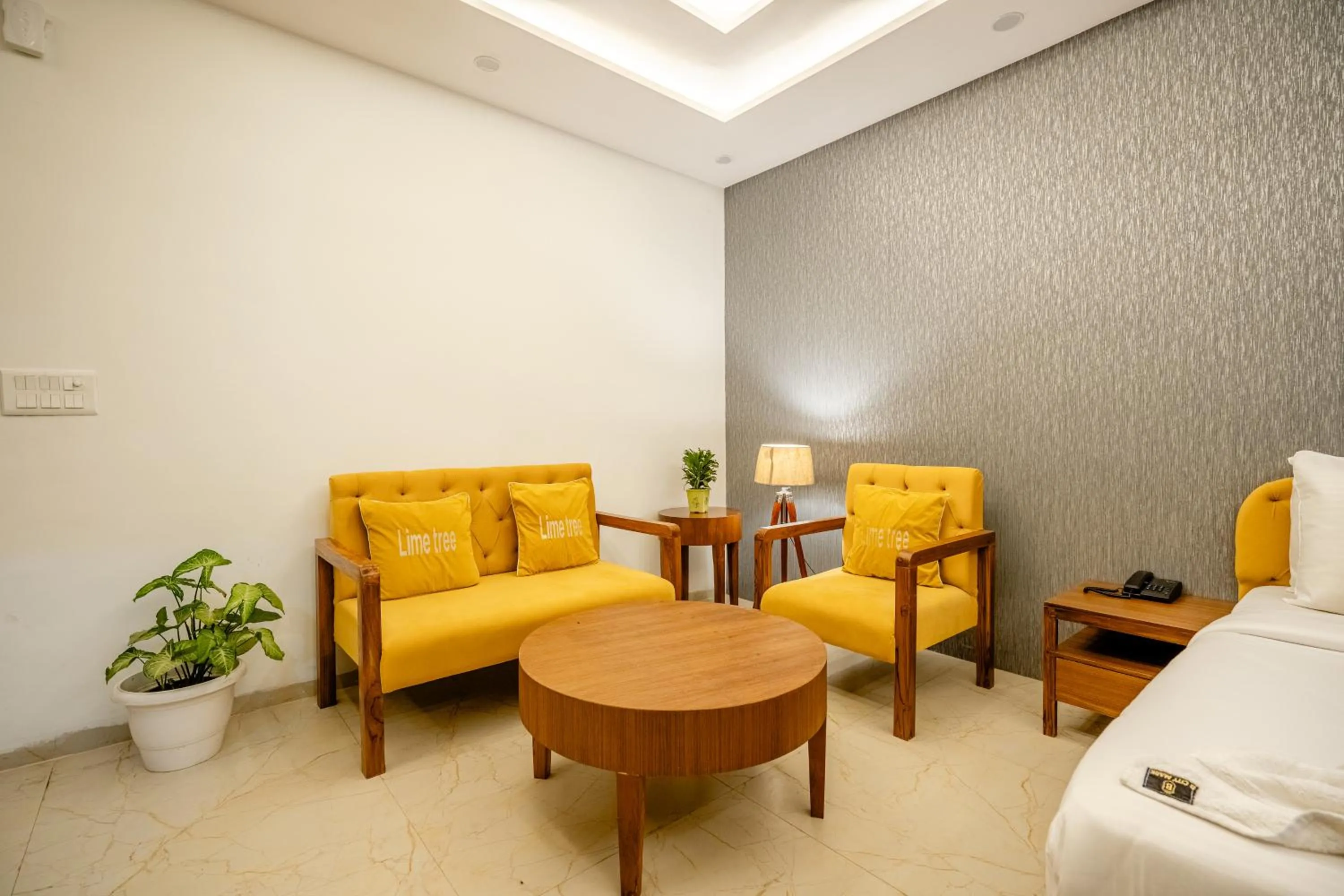 Living room, Bed in Lime Tree Hotels and Banquet Greater Noida