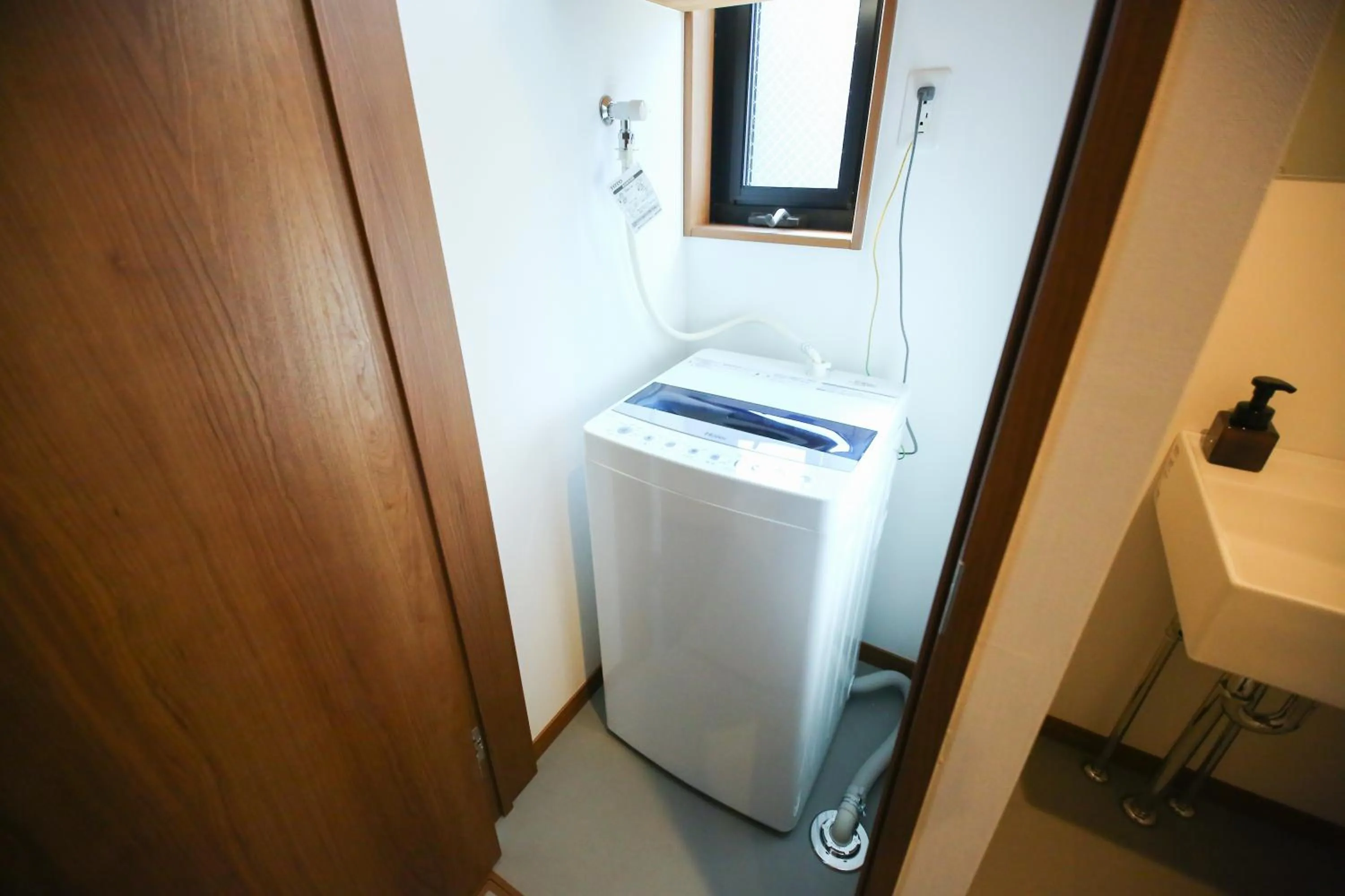 washing machine in PrimeRoom別府 TATAMIsuite