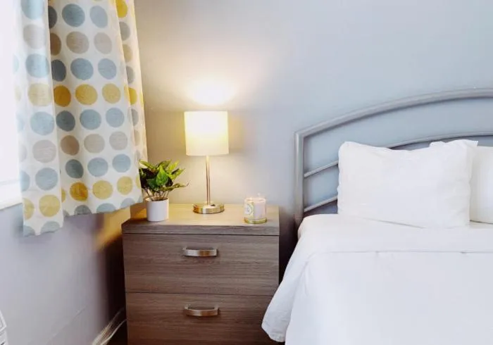 Bed in Great Escape Apartments By Lowkl