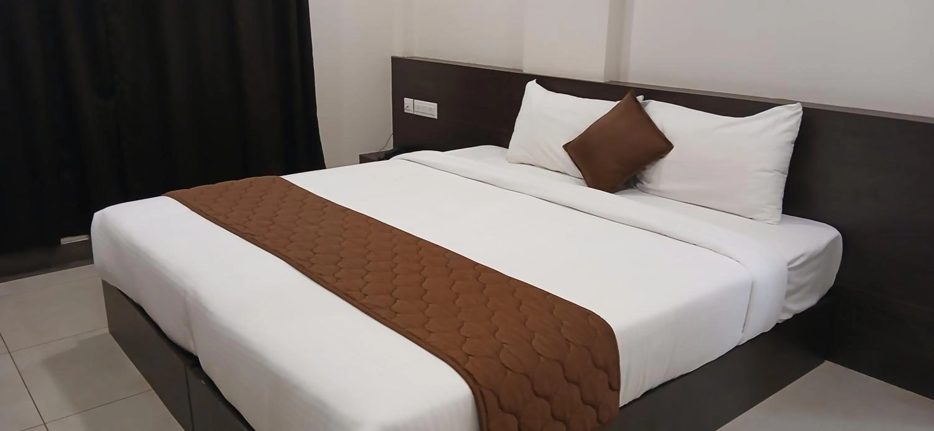 Bed in HOTEL PANKAJ RESIDENCY