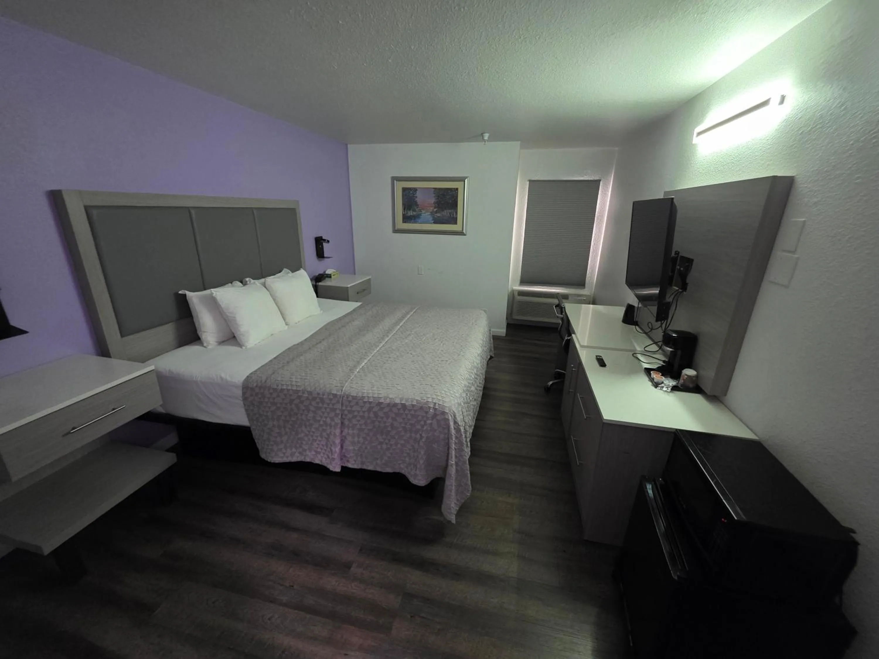 Bed in The Aqua Pacific Hotel