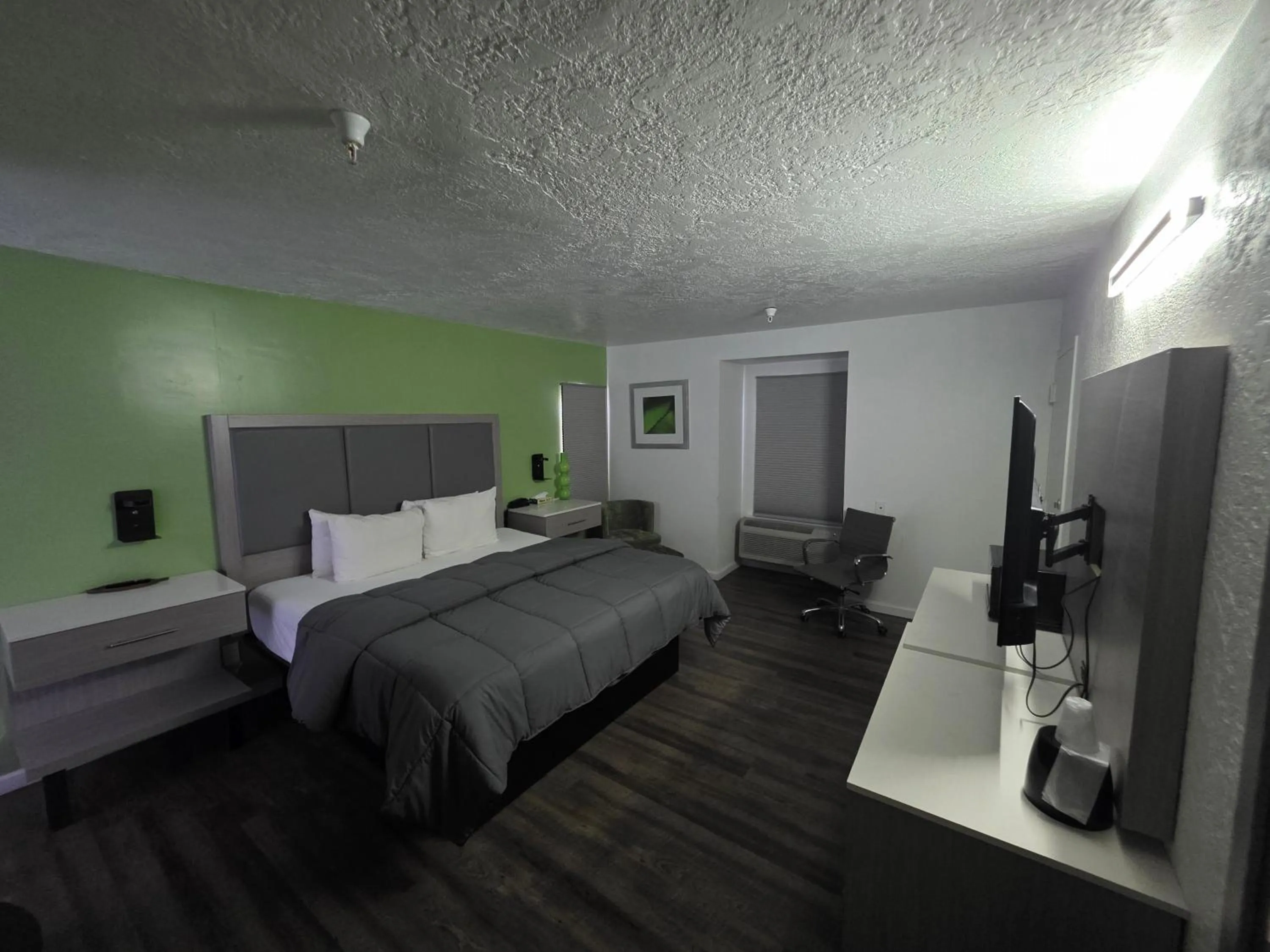 Bed in The Aqua Pacific Hotel