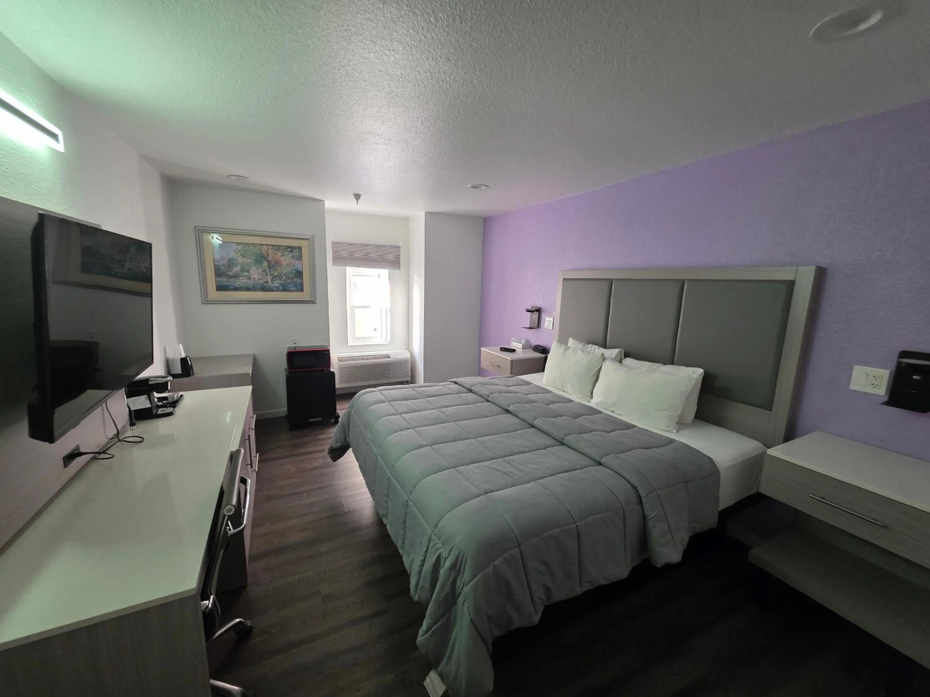 Bed in The Aqua Pacific Hotel