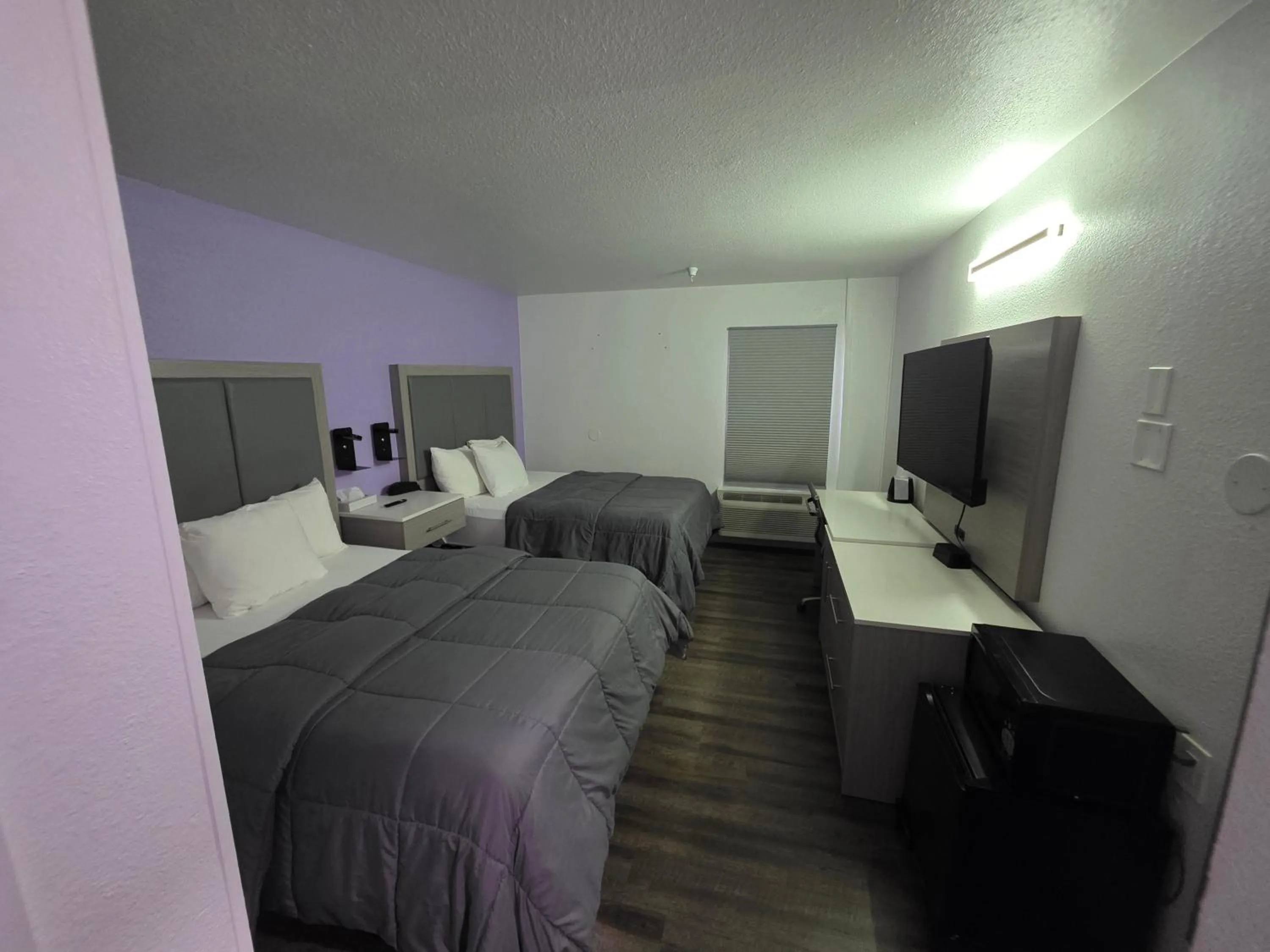 Bed in The Aqua Pacific Hotel