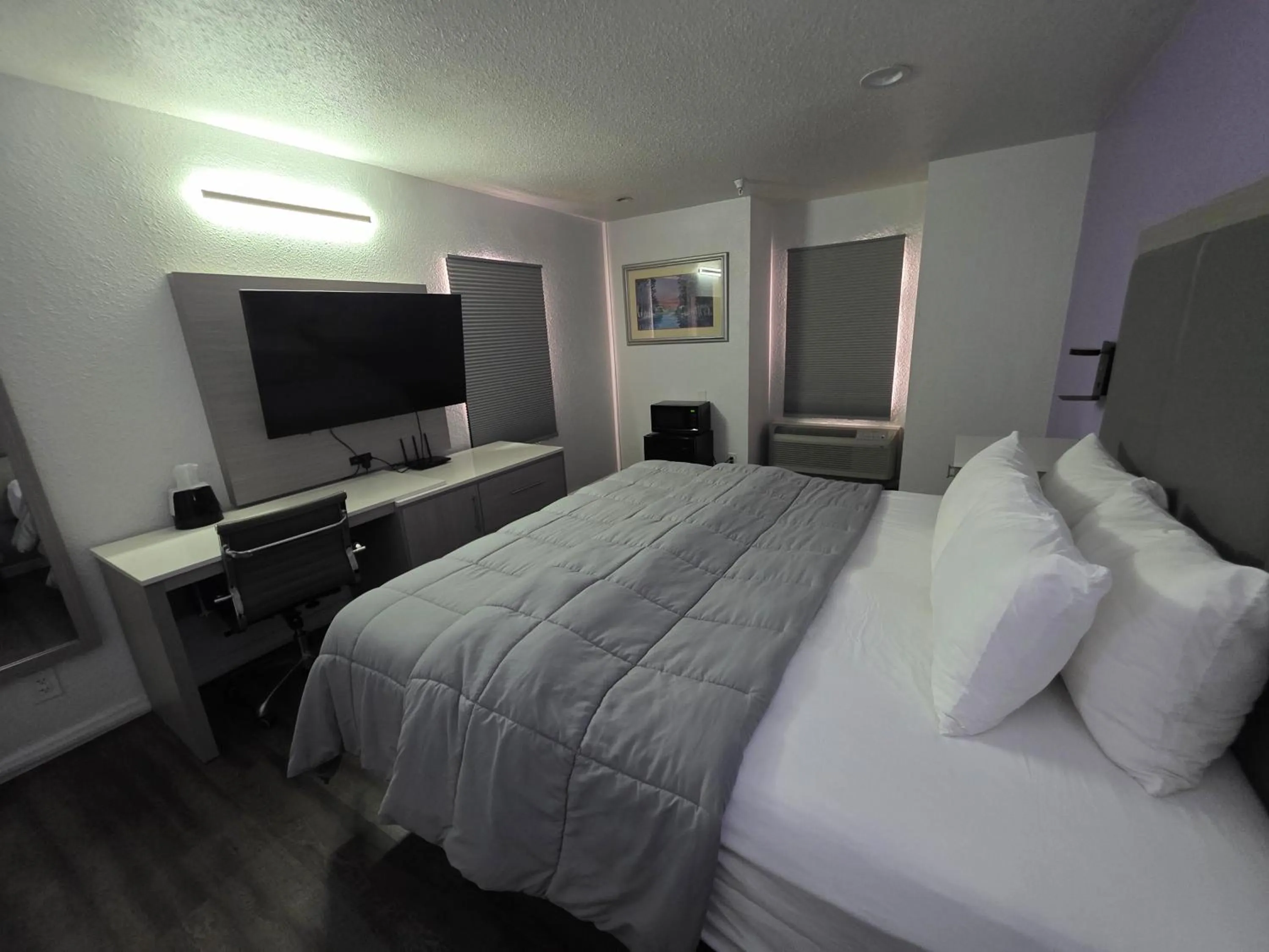 Bed in The Aqua Pacific Hotel